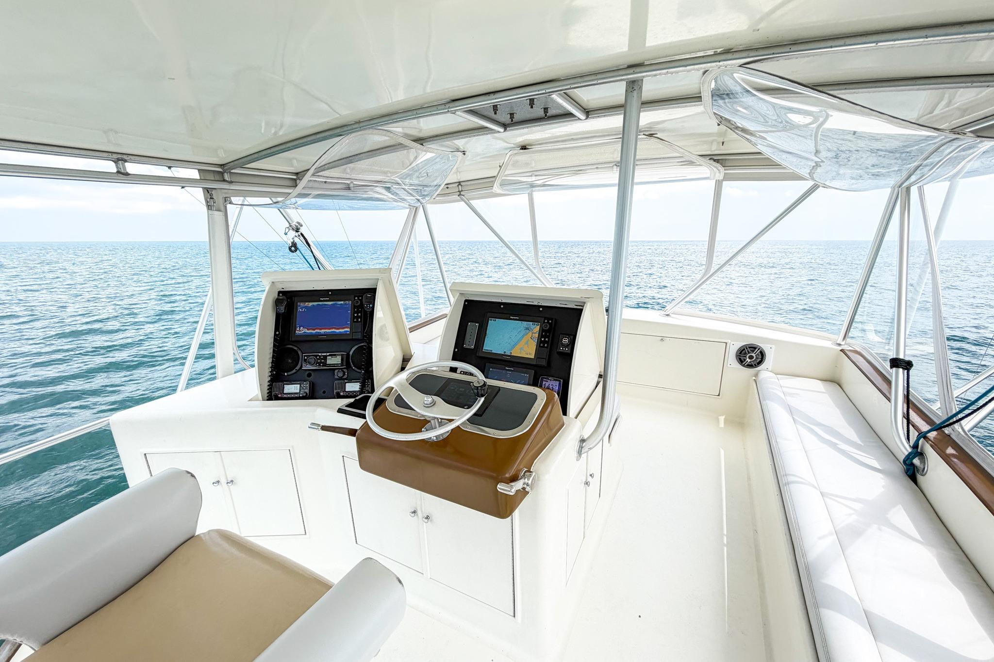 Helm of 1998 Blackwell Custom Carolina Sportfish overlooking the ocean, featuring navigation equipment.