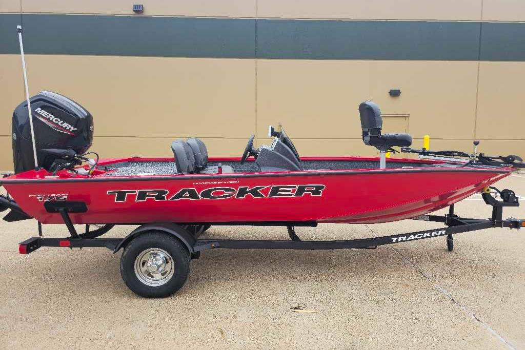 2026 Tracker Pro Team 175 Crappie Edition boat, red, on trailer, side view.