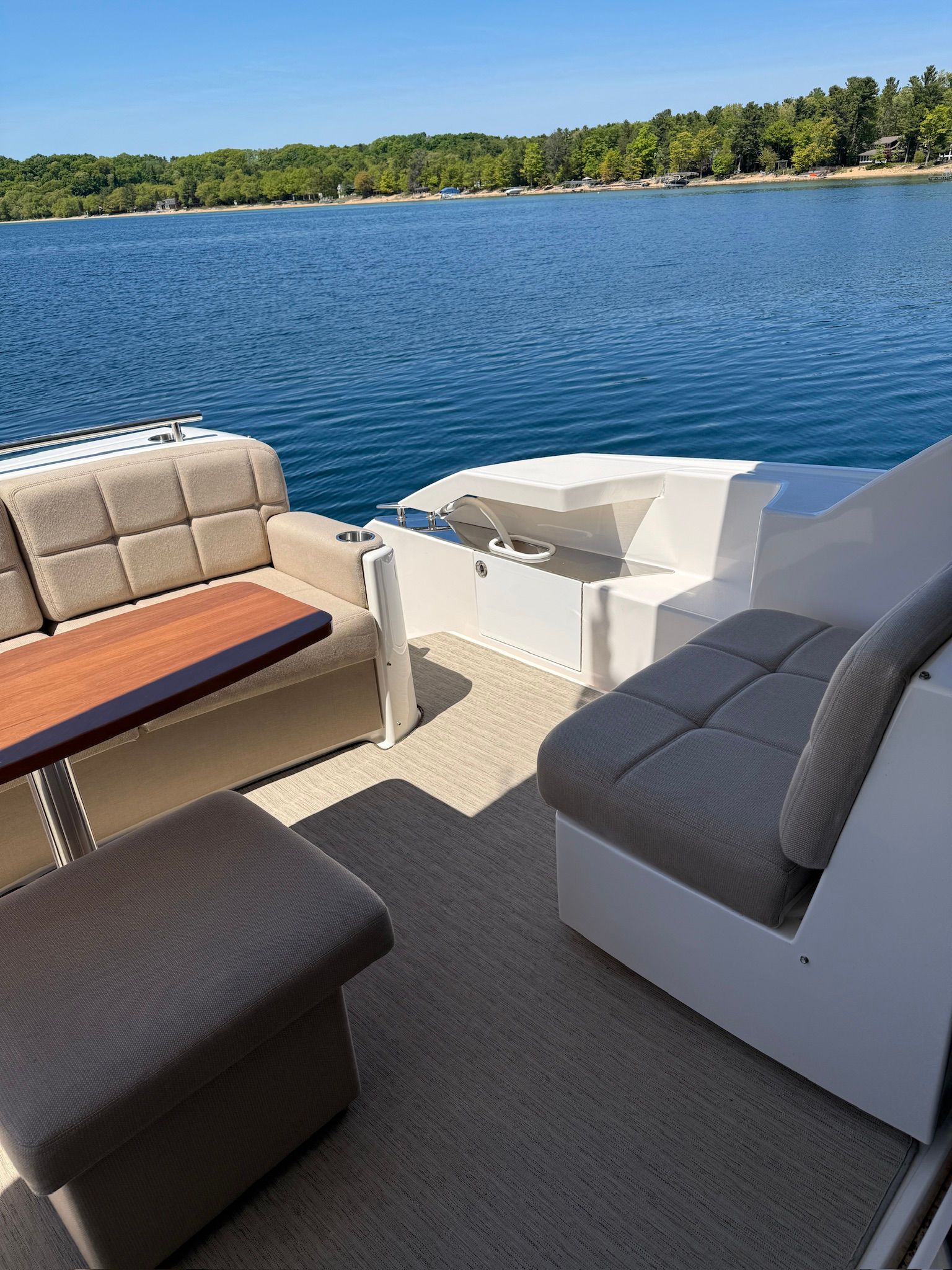 The image shows the deck of a 2017 Tiara Yachts C44 Coupe on calm water.