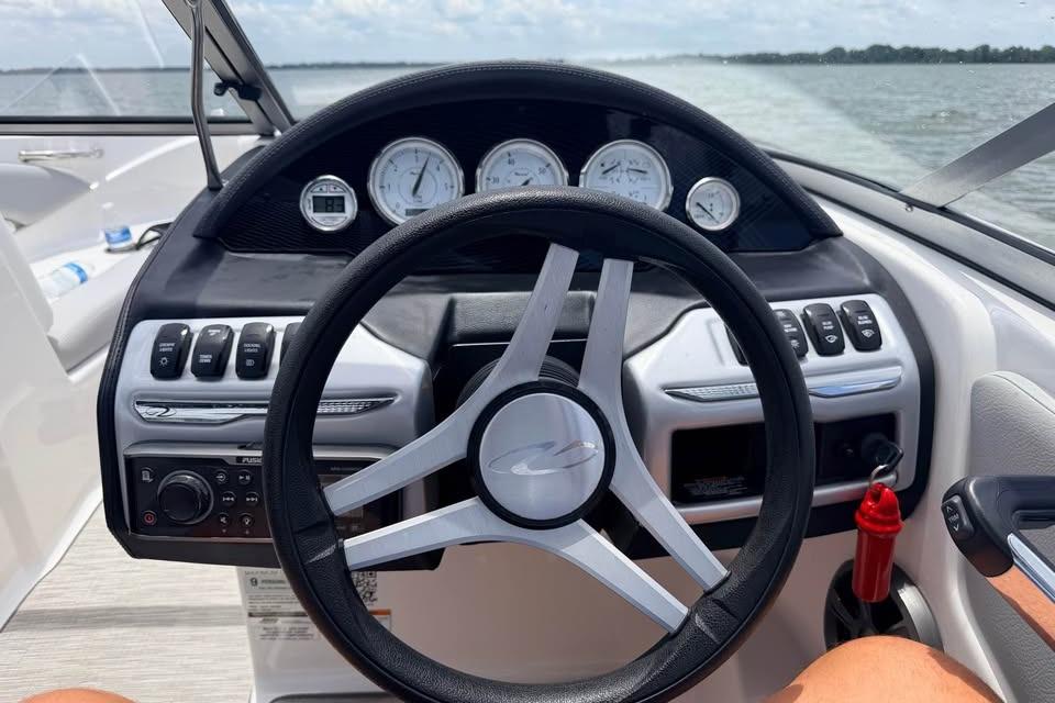 Steering wheel and dashboard of a 2019 Regal 1900 ES Bowrider on open water.