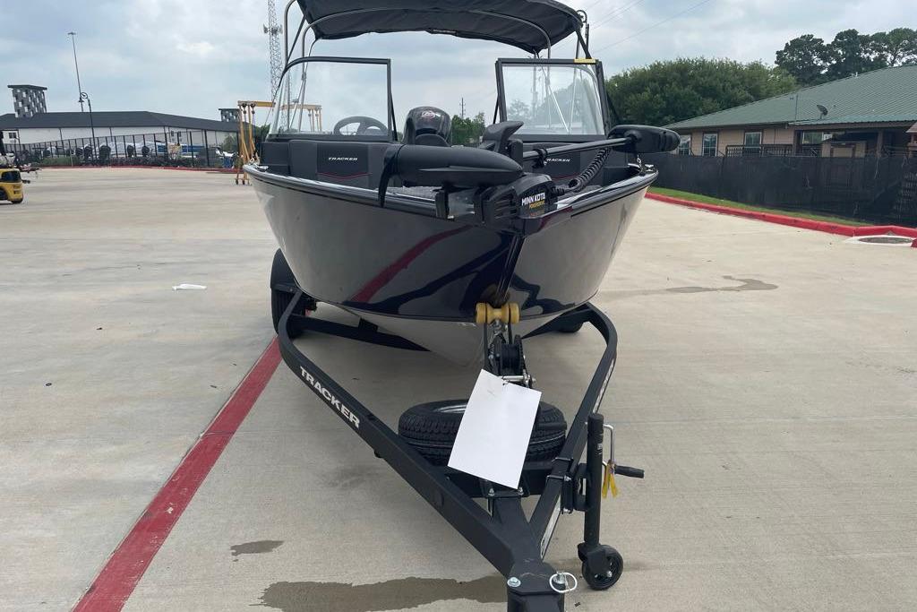 2026 Tracker Pro Guide V-175 Combo boat on trailer in parking lot.