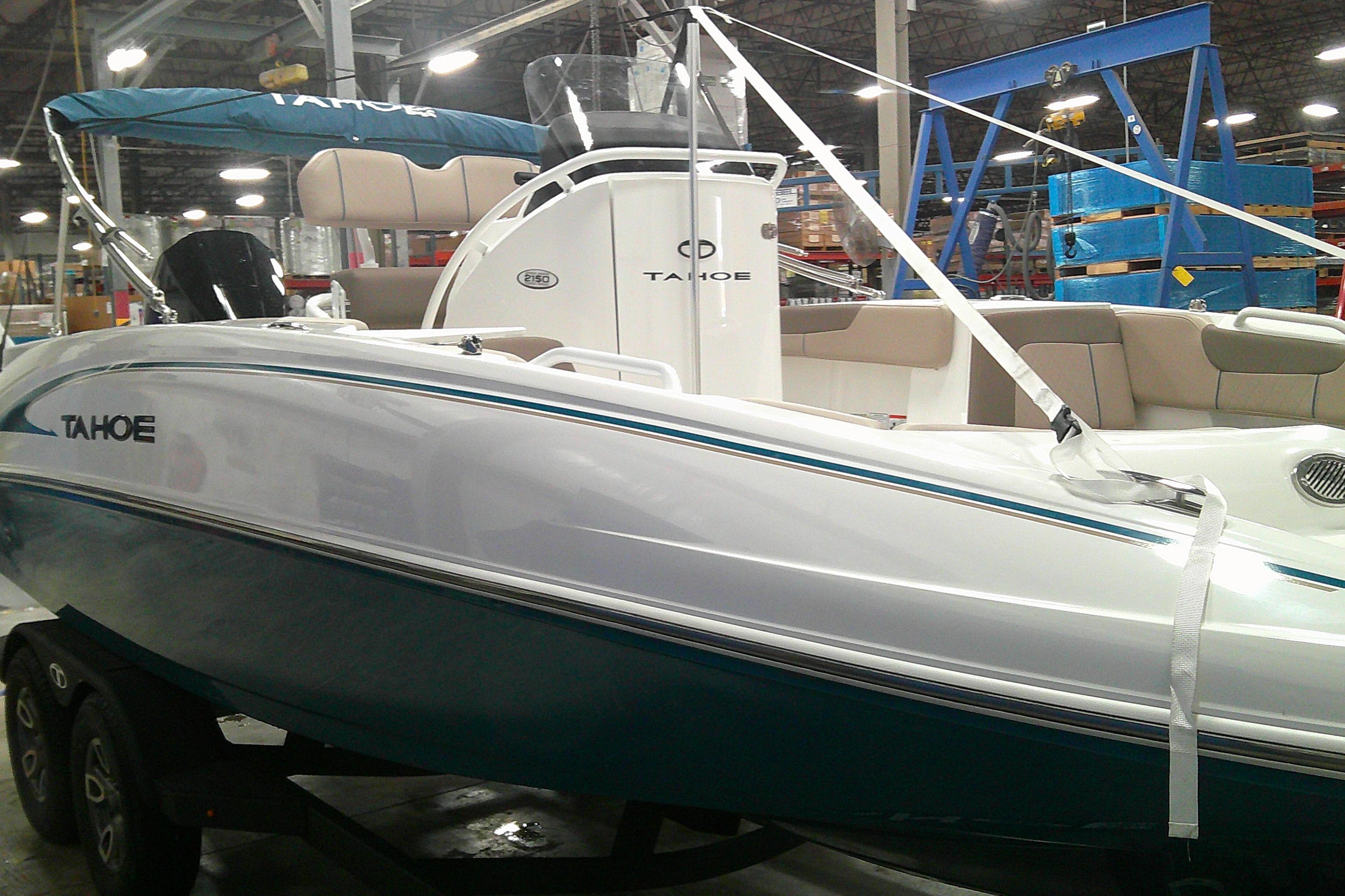 2026 Tahoe 2150 CC boat in showroom, featuring sleek design and modern amenities.