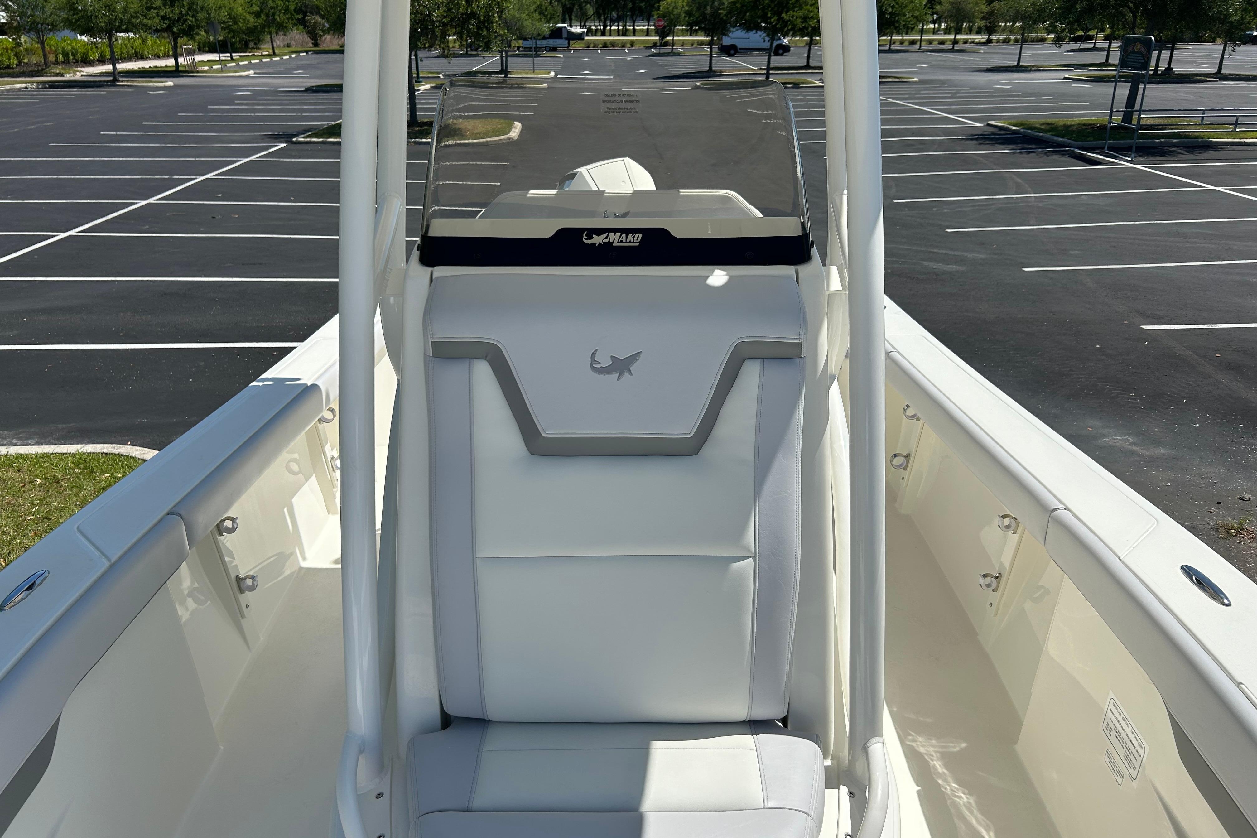 2026 Mako 226 Center Console boat in empty parking lot, showcasing seating area.