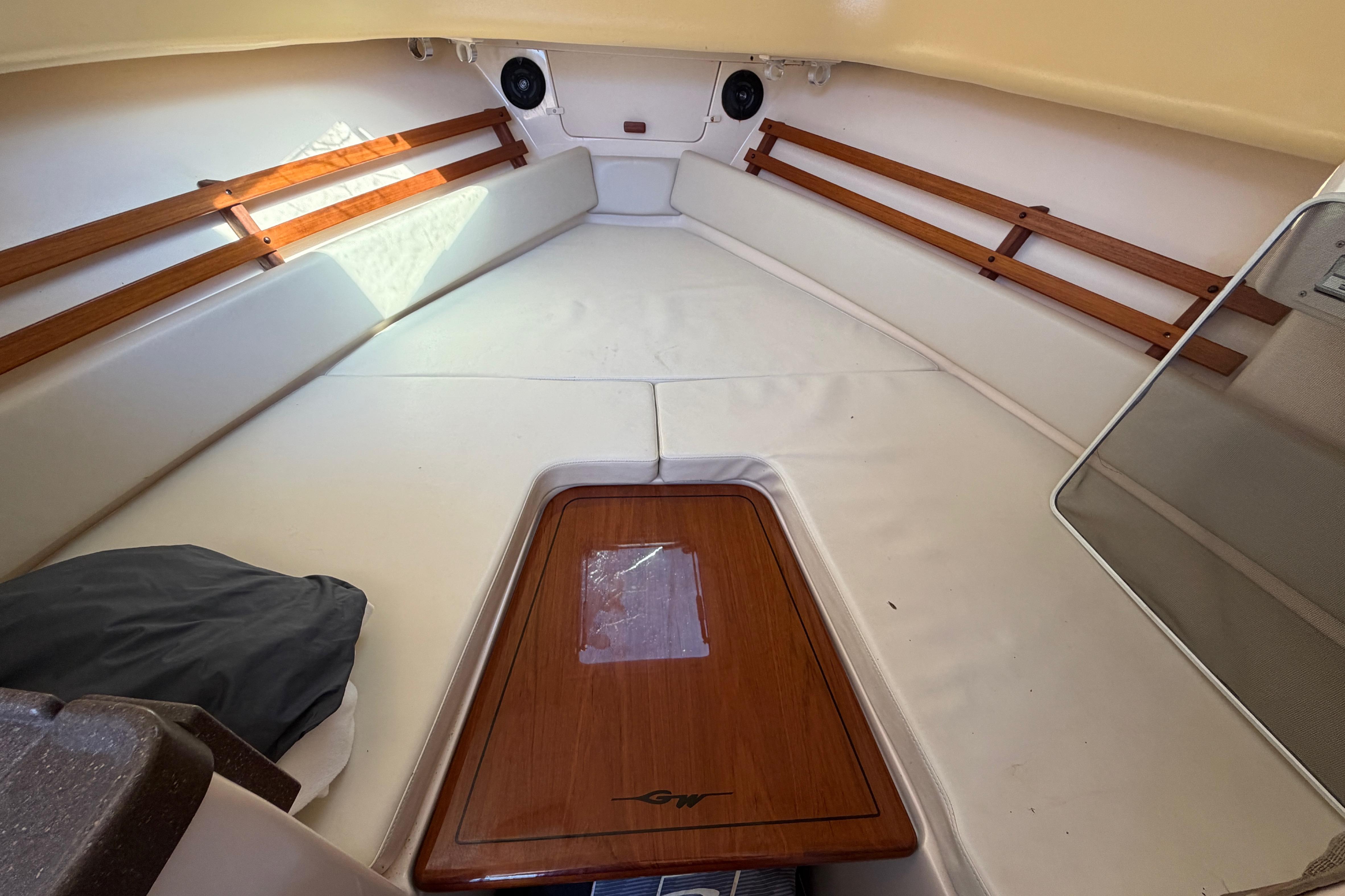 2006 Grady-White Sailfish 282 cabin interior with cushioned seating and wooden accents.