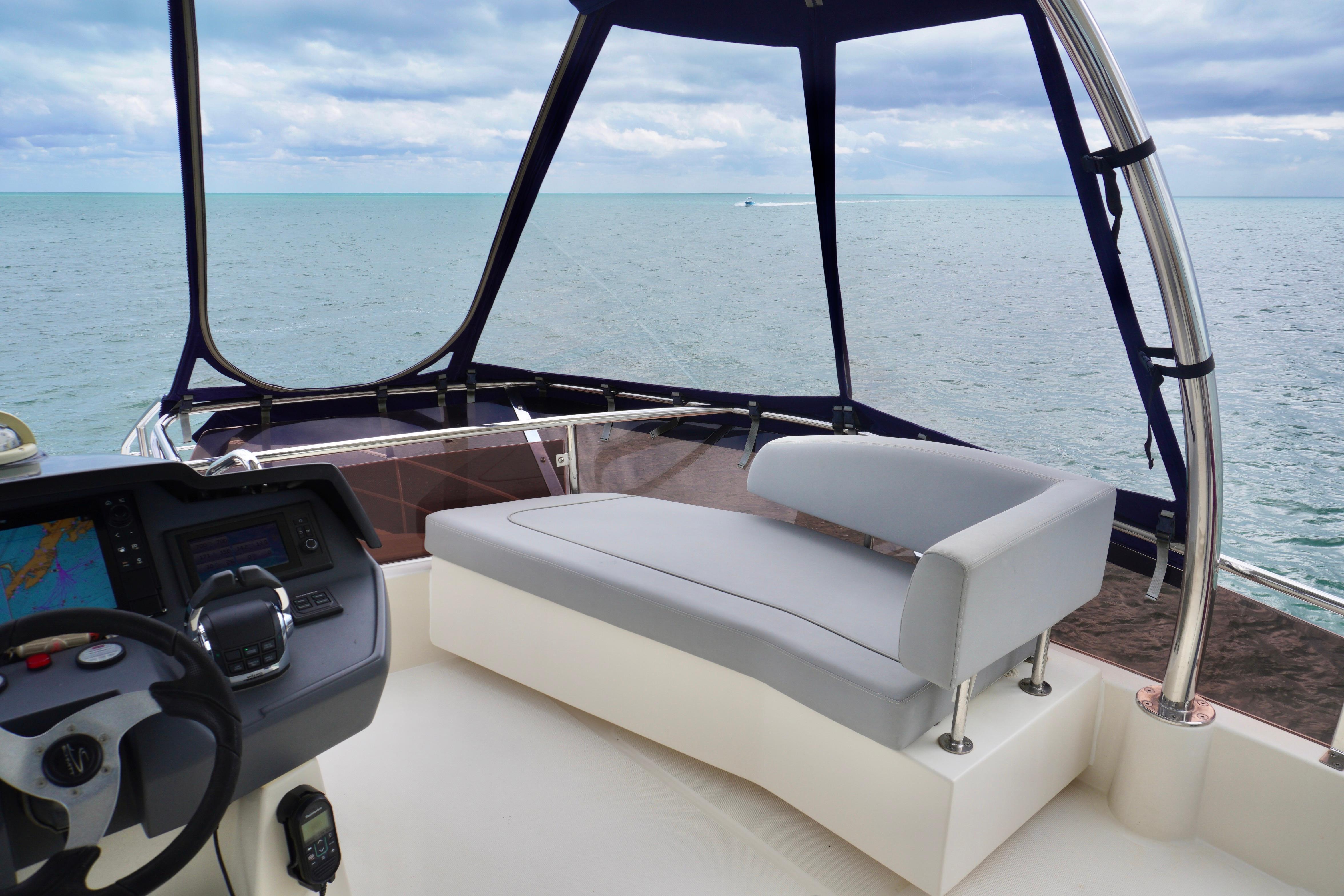 Aquila 44 Yacht 2017 helm with ocean view, featuring modern seating and navigation controls.