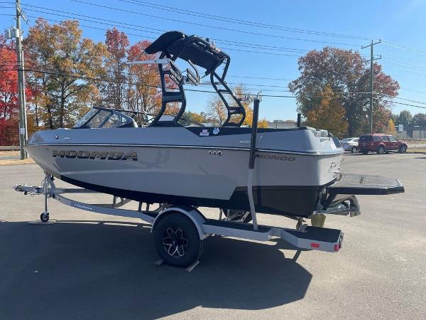 2025 Moomba Mondo boat on trailer, parked outdoors with autumn trees in background.