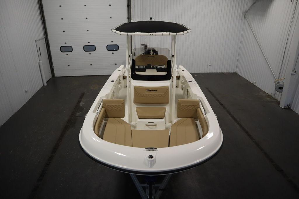 2026 Bayliner Trophy T20CC boat in indoor storage, featuring beige seating and sleek design.