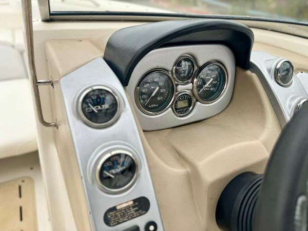 2006 Larson LXi 248 boat dashboard with gauges and controls.