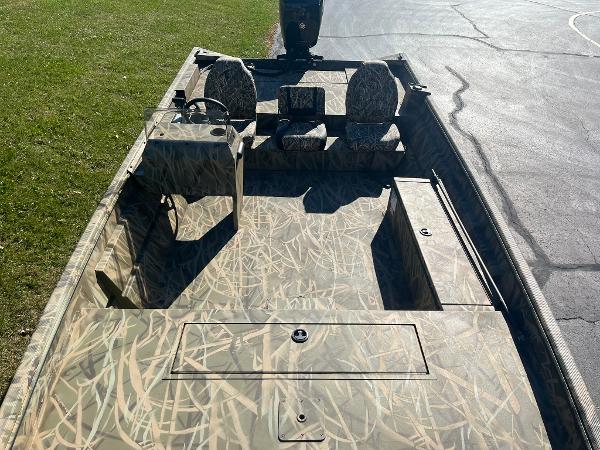 2025 Lowe Roughneck 2070 SC boat with camouflage design on a sunny day.