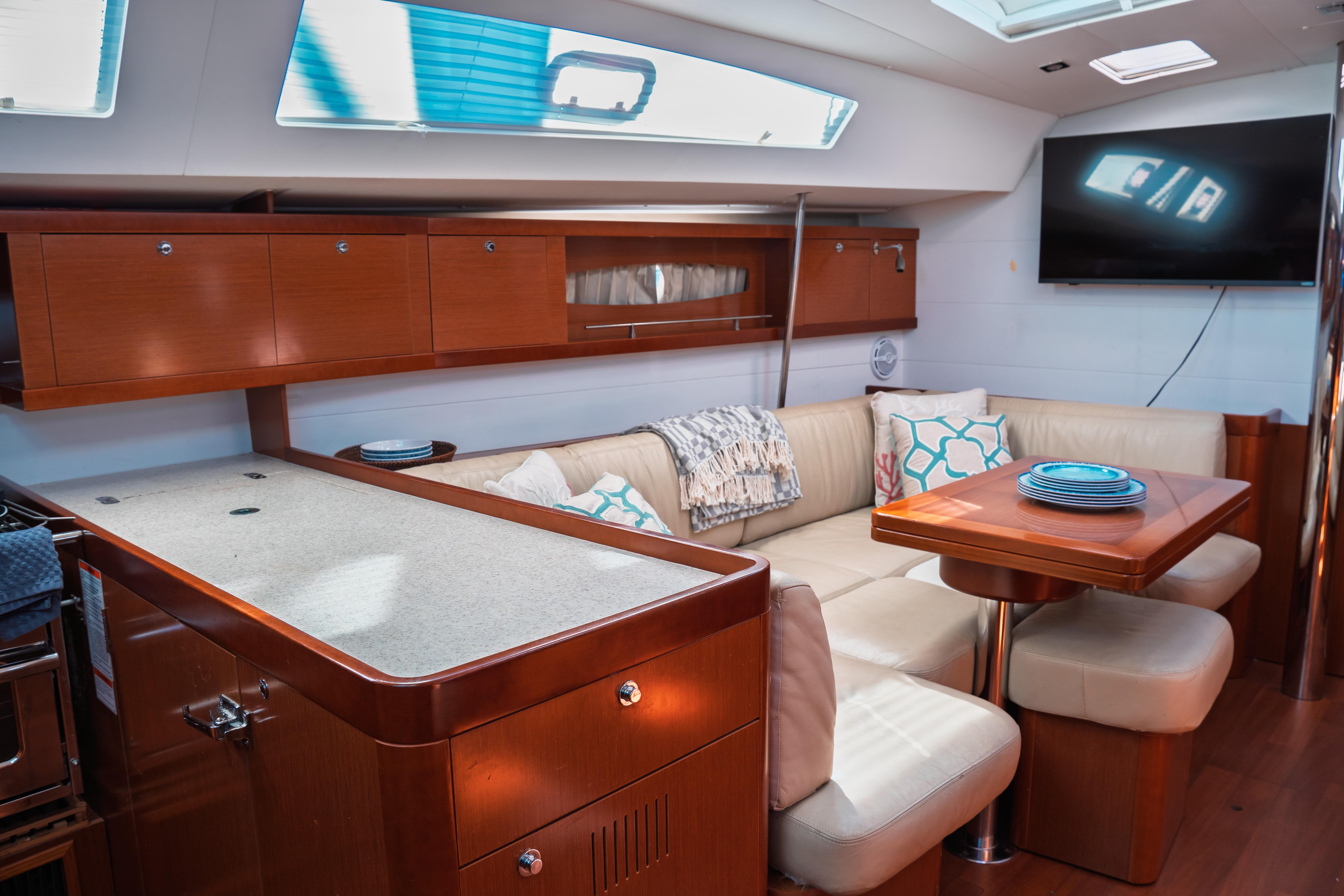 Luxurious interior of 2011 Beneteau Oceanis 50 yacht with modern seating and elegant wood finishes.