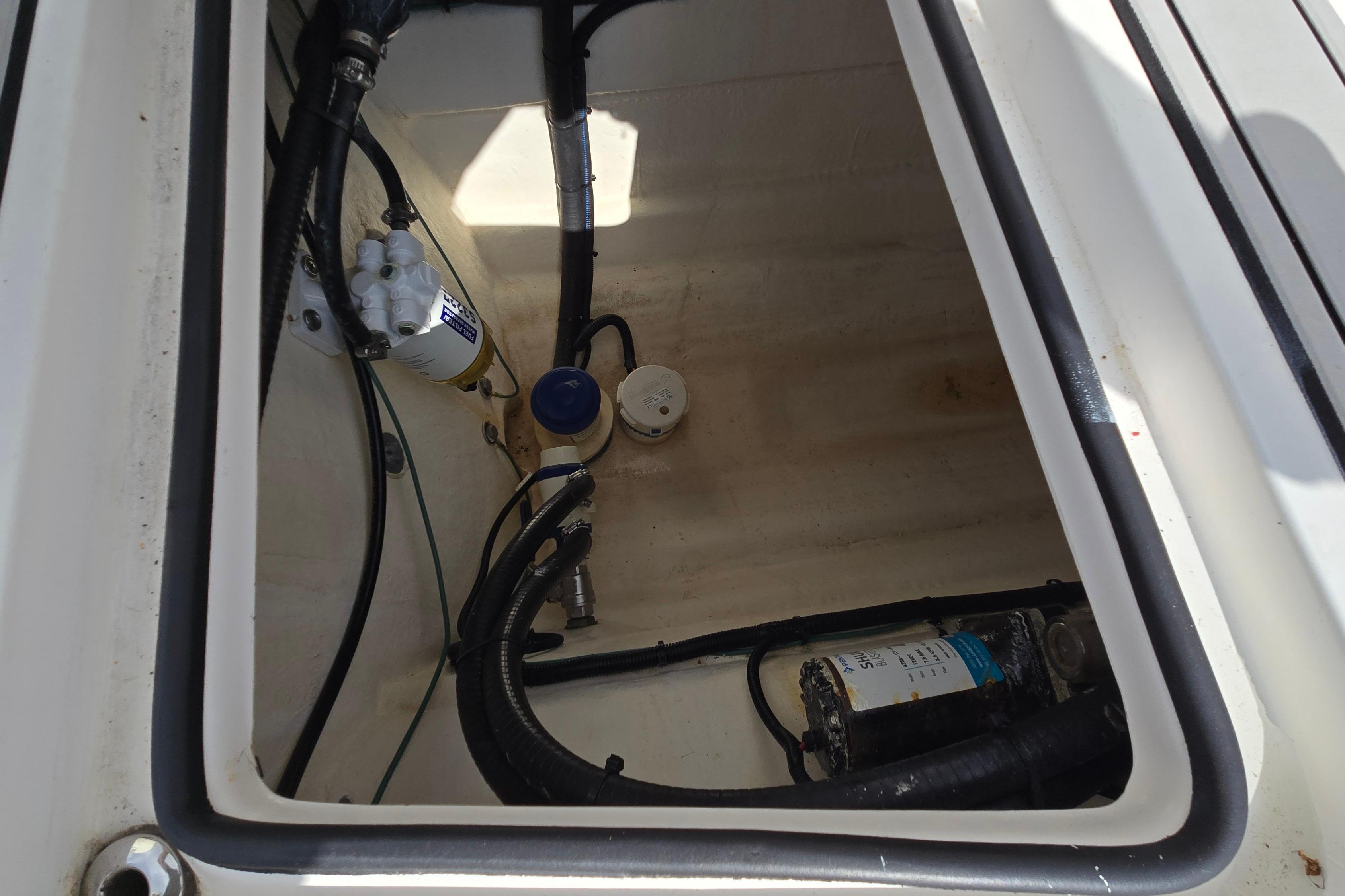 2020 Twin Vee 240 DC GF boat compartment with hoses and equipment.