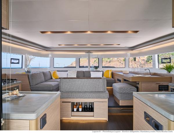 Luxurious interior of 2025 Lagoon 51 ICONIC yacht with modern furnishings and panoramic windows.