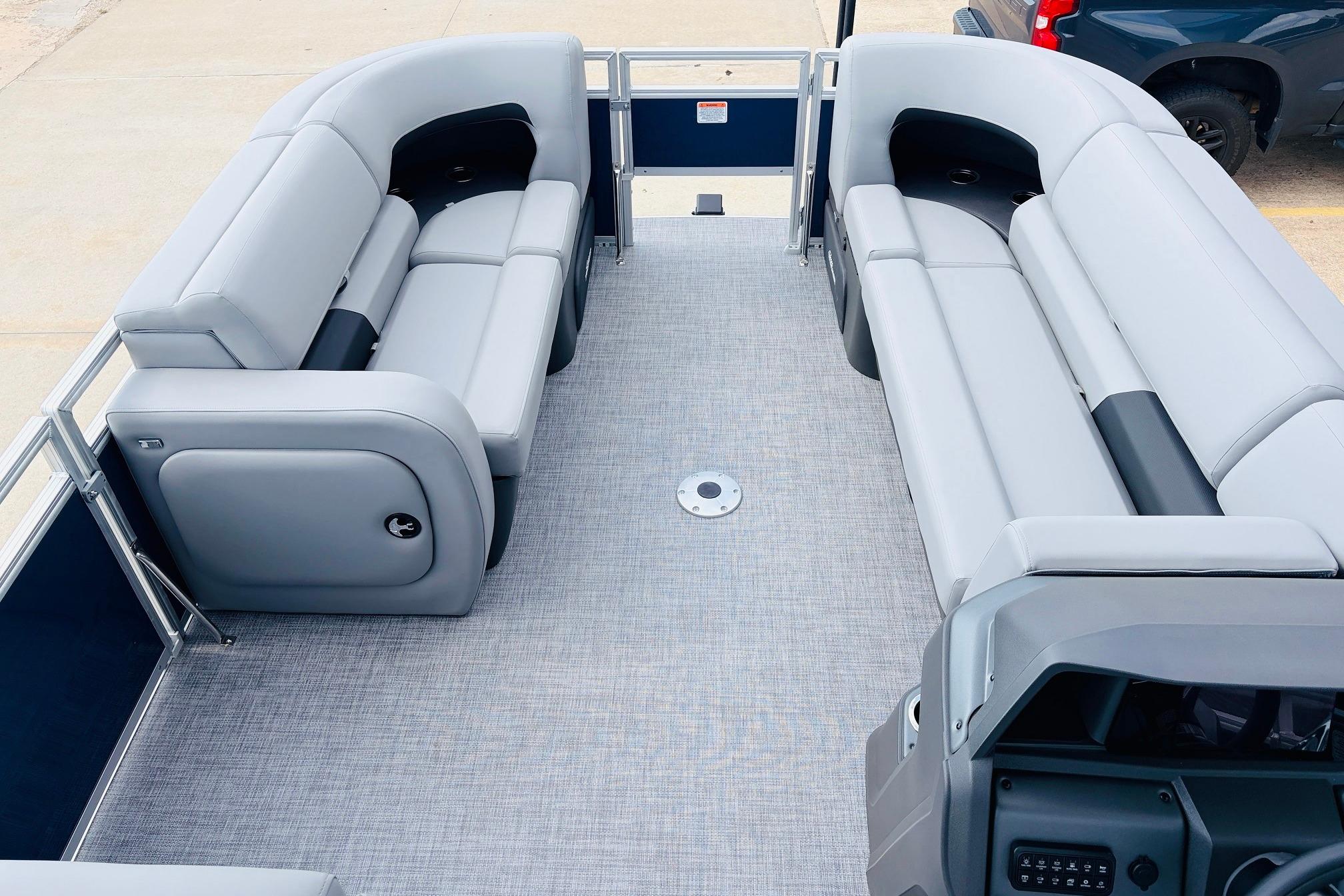 2026 Sun Tracker SportFish 22 DLX pontoon boat interior with gray seating and spacious layout.