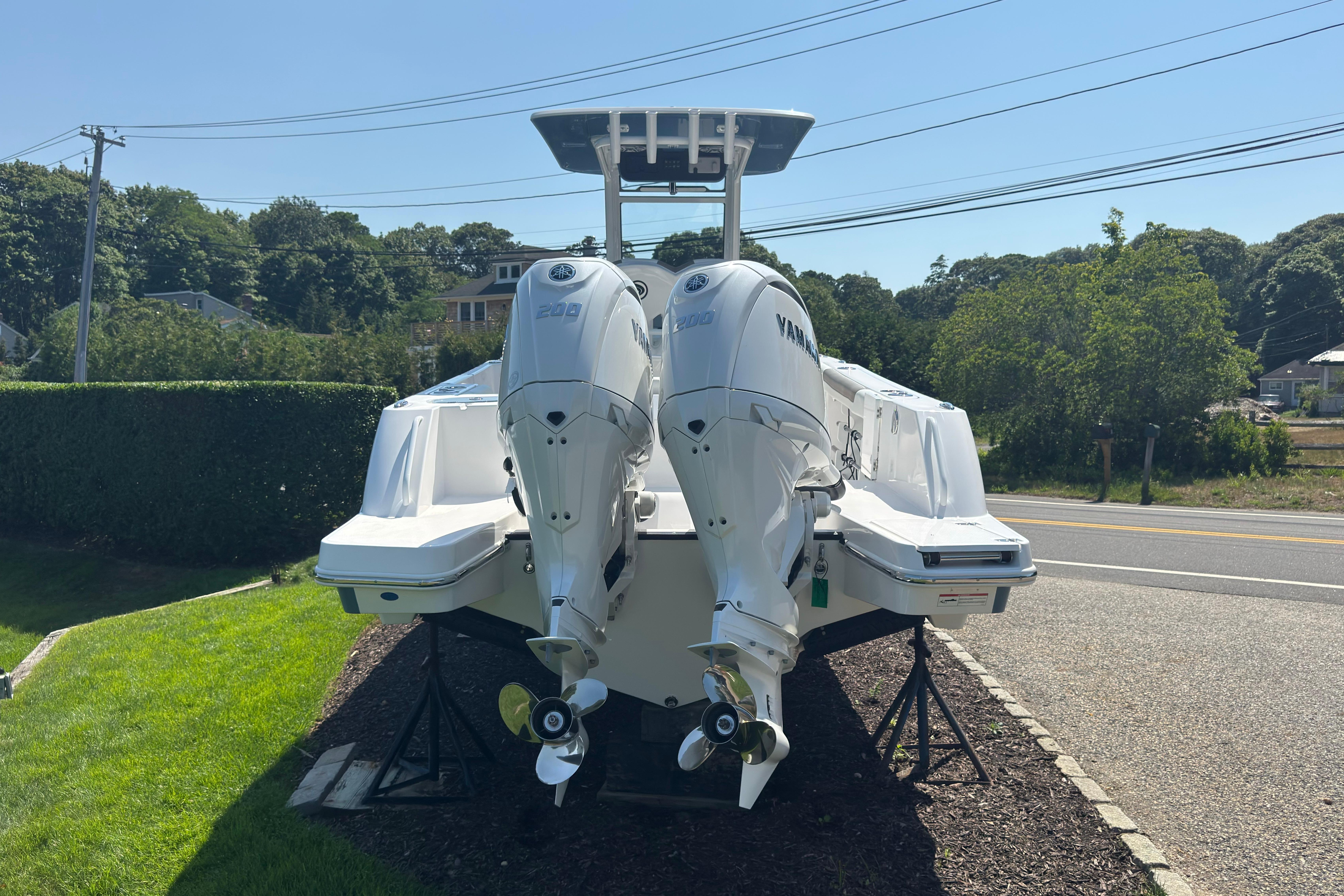 2026 Edgewater 250CC boat with dual Yamaha outboard engines on display outdoors.