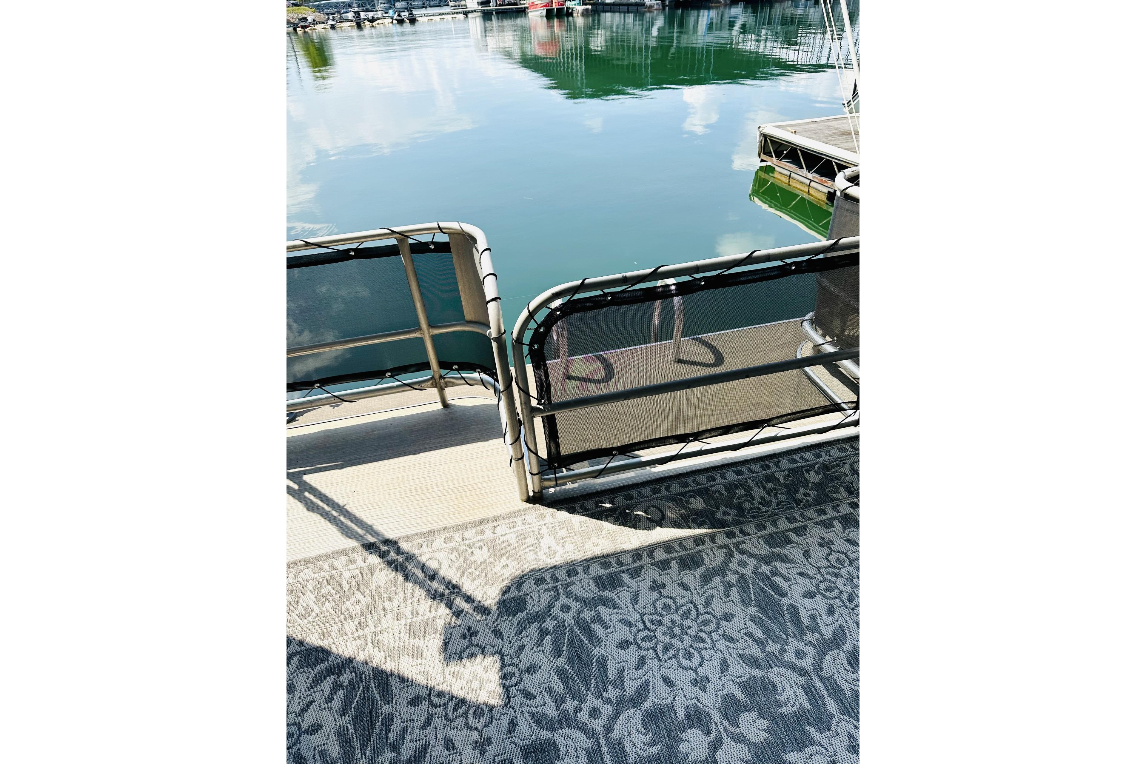 1992 Sumerset 66 houseboat deck with patterned carpet and lake view.