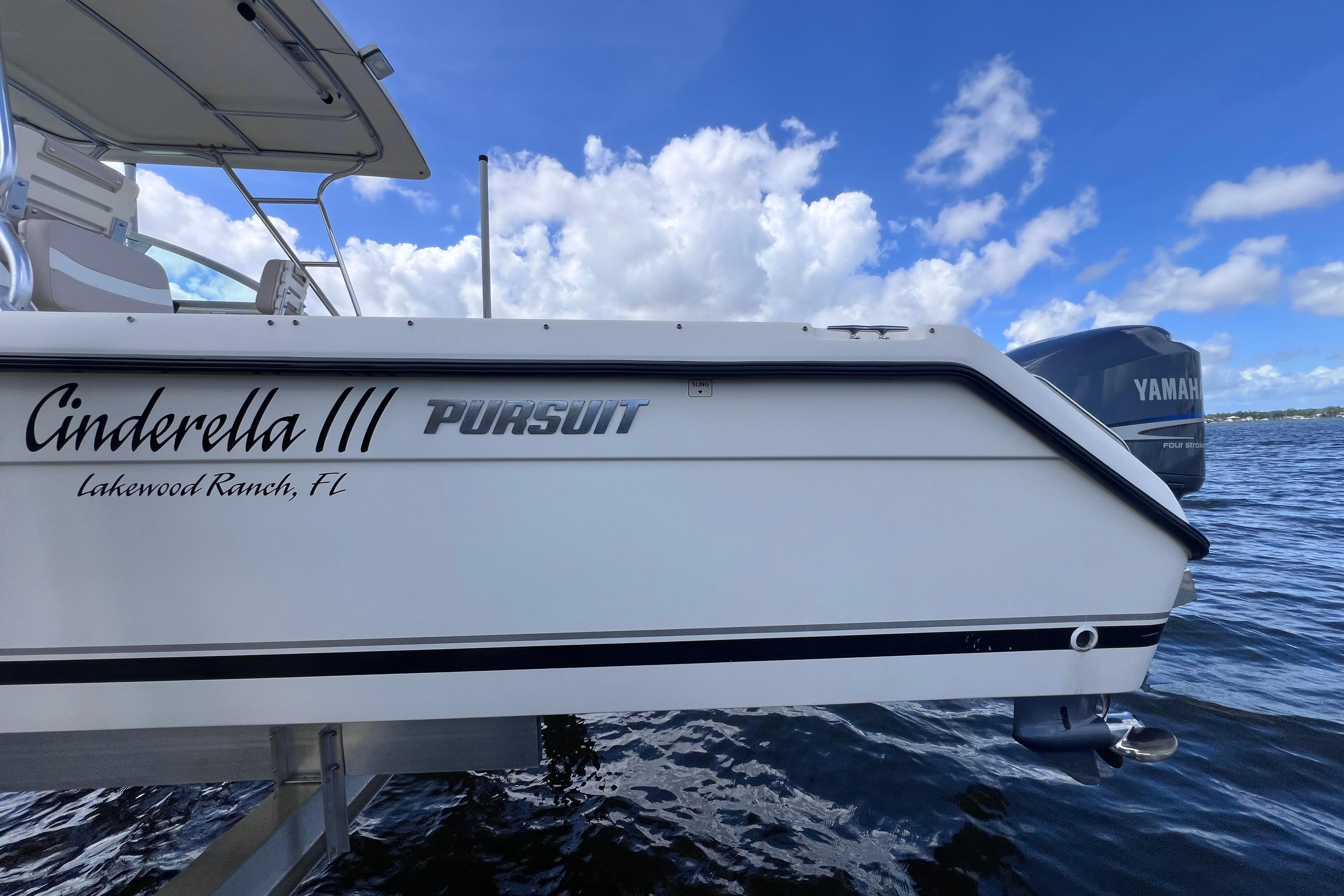 2004 Pursuit 2870 Walkaround boat on water, featuring Yamaha engine, clear sky background.