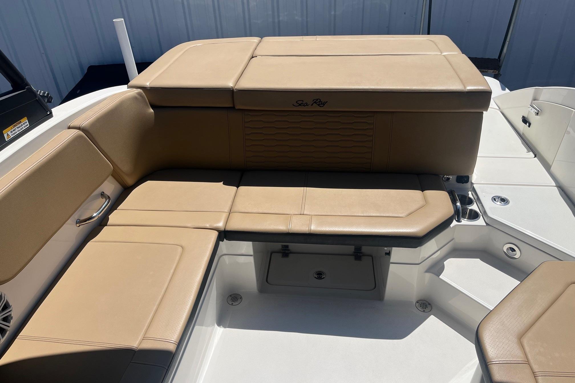 2024 Sea Ray SPX 230 boat interior with tan leather seating and storage compartments.
