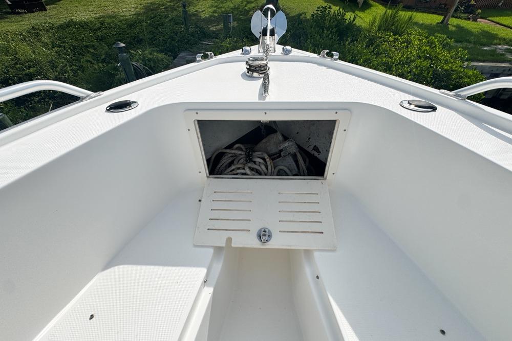 2018 Mako 284 Center Console boat with open storage compartment, showcasing ropes and anchor.