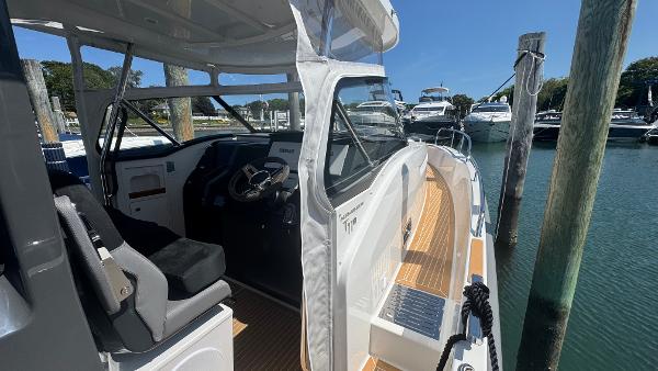 2025 Nimbus T11 boat docked, showcasing sleek design and modern interior.
