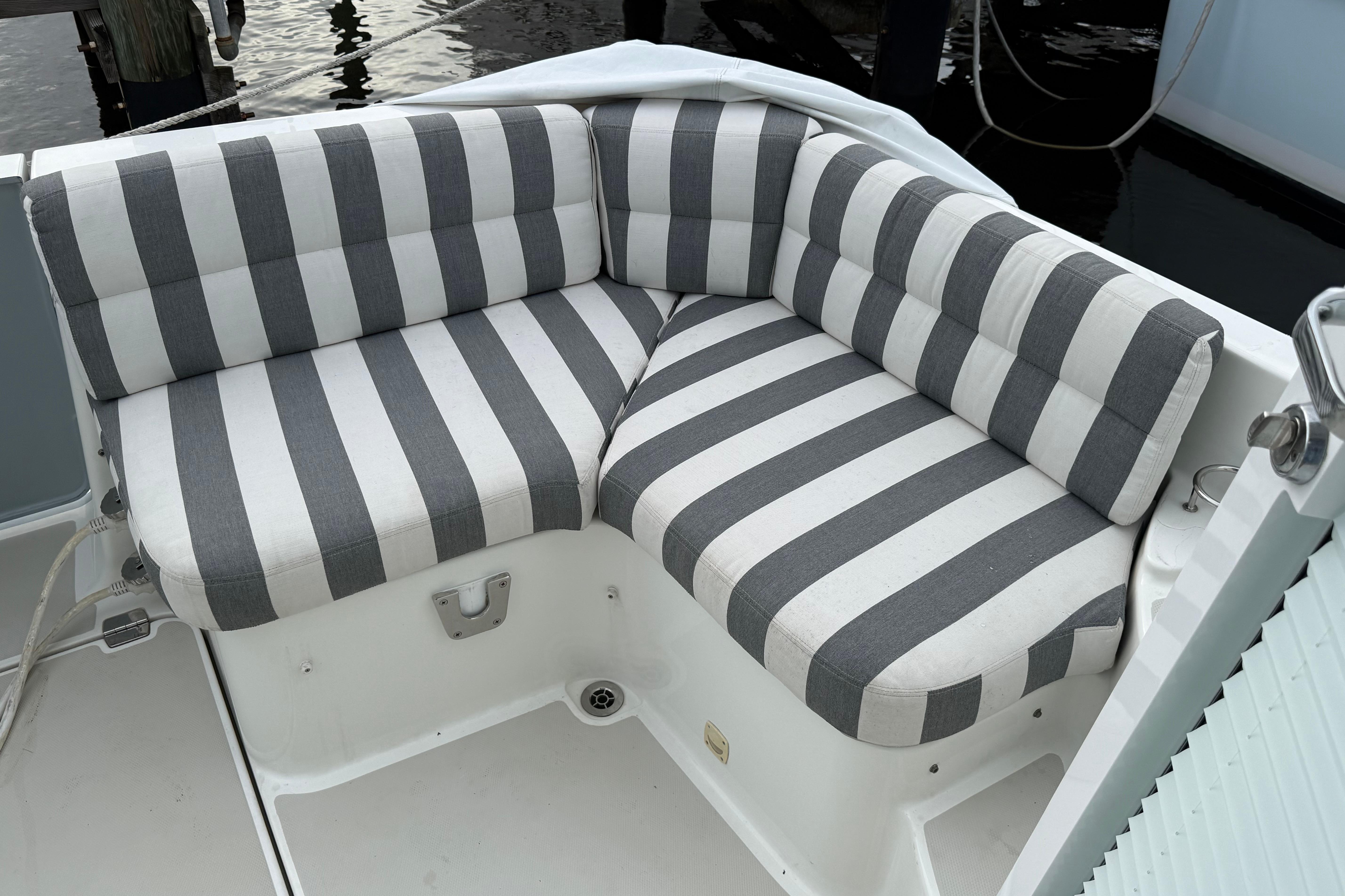 Striped cushioned seating on a 2011 Back Cove Downeast 37 boat deck.