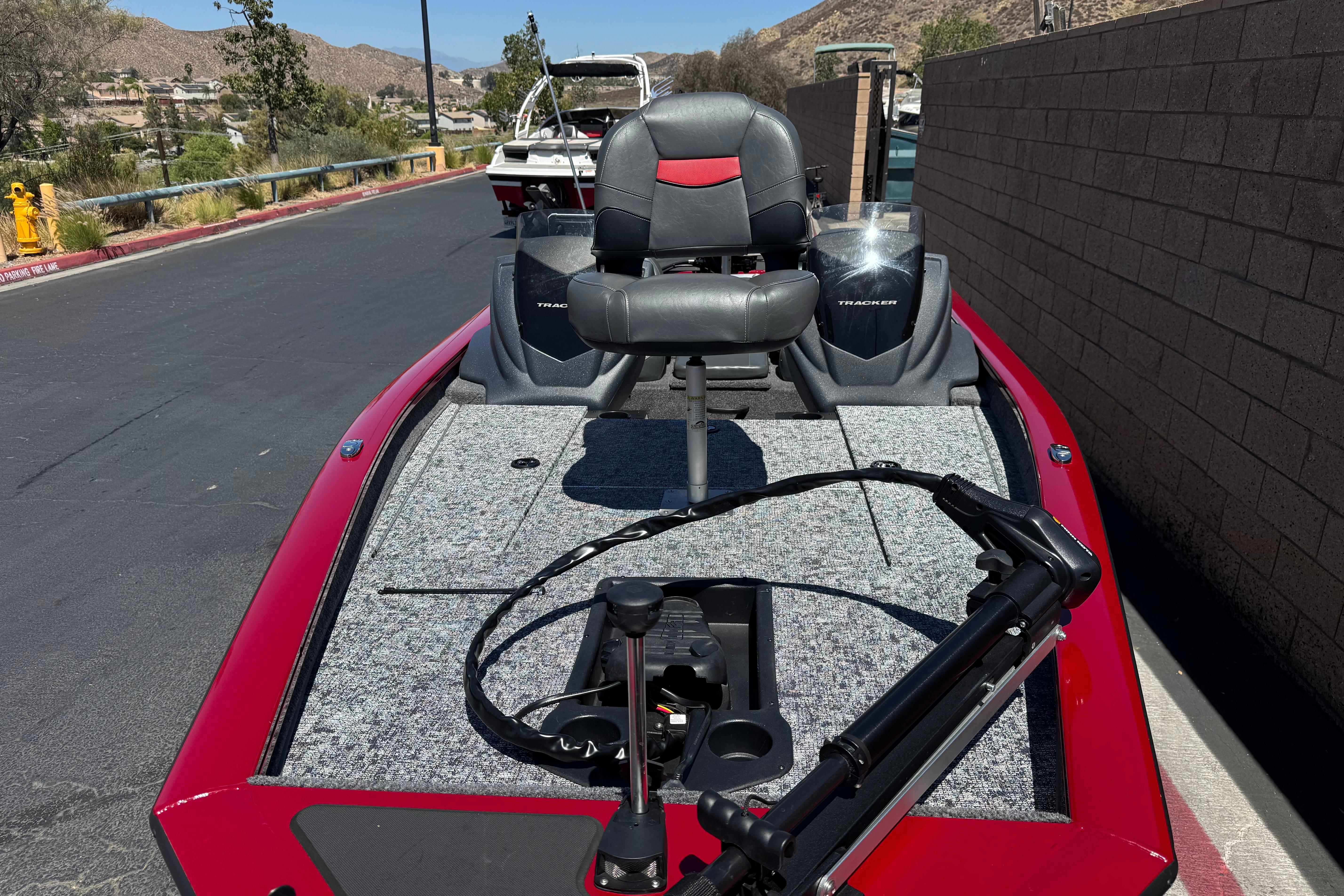 2025 Tracker Pro Team 175 TXW boat with red exterior and fishing seat.