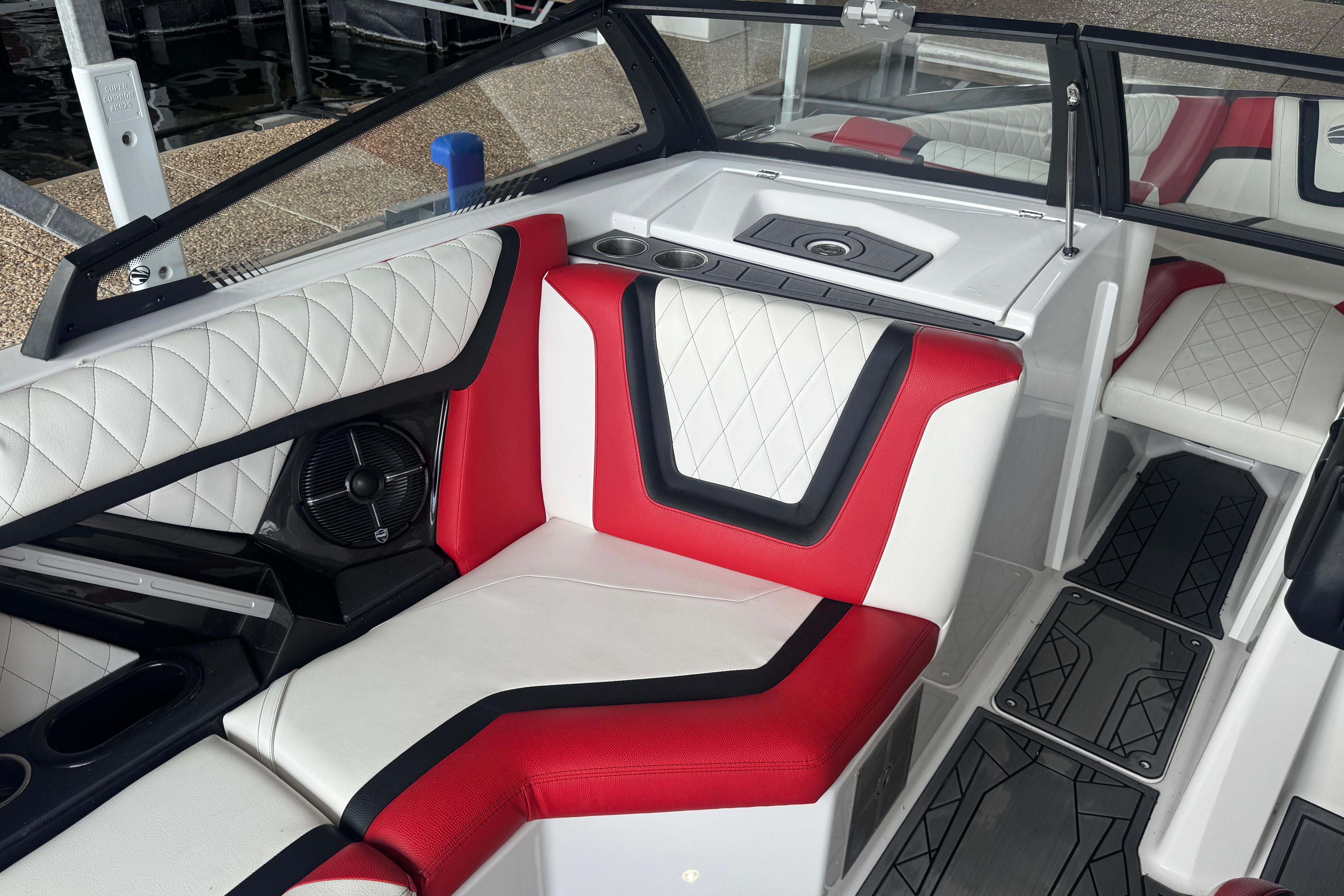 Interior of 2020 Tige 25ZX boat with red and white seating.