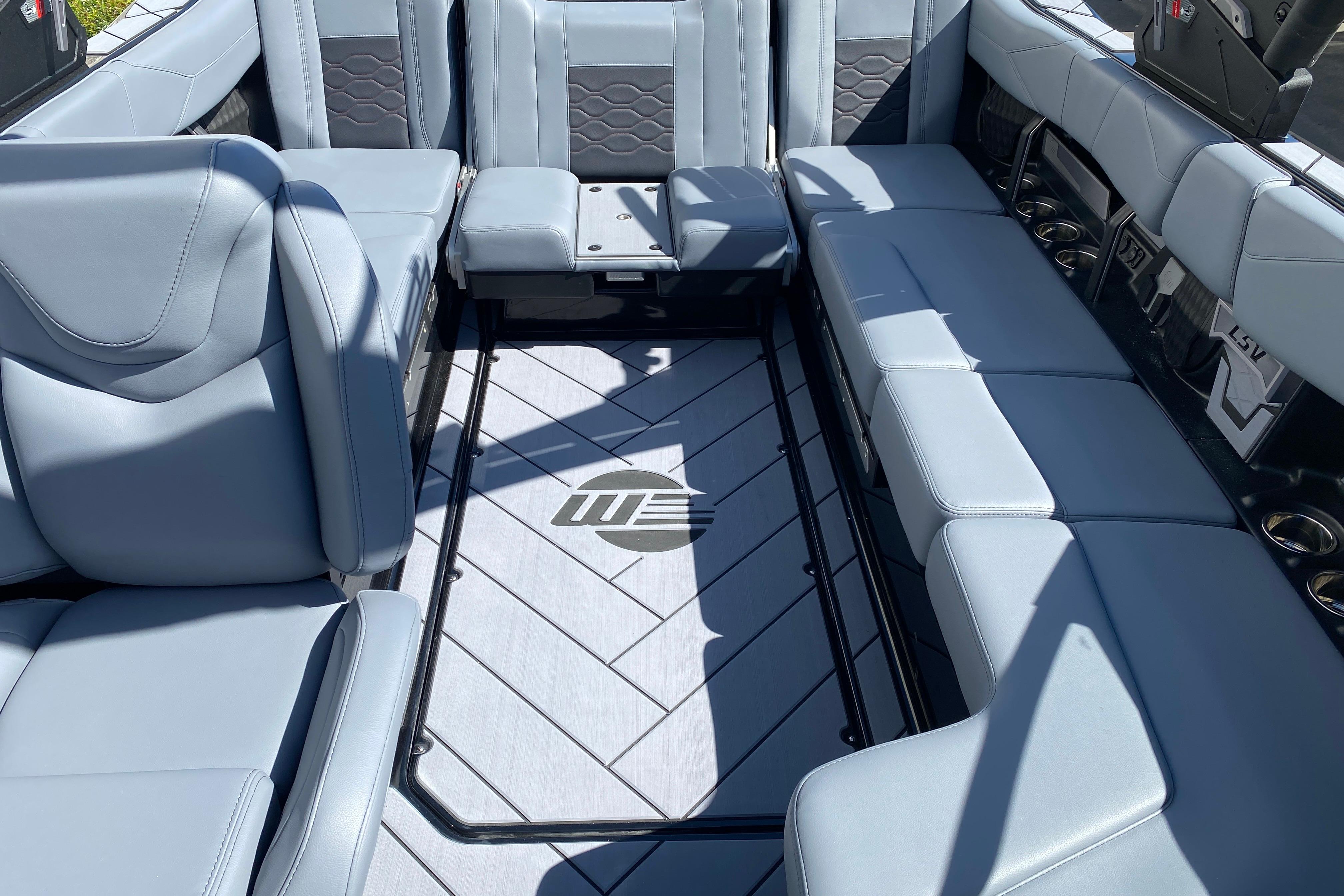 2025 Malibu Wakesetter 23 LSV interior with sleek gray seating and stylish flooring.
