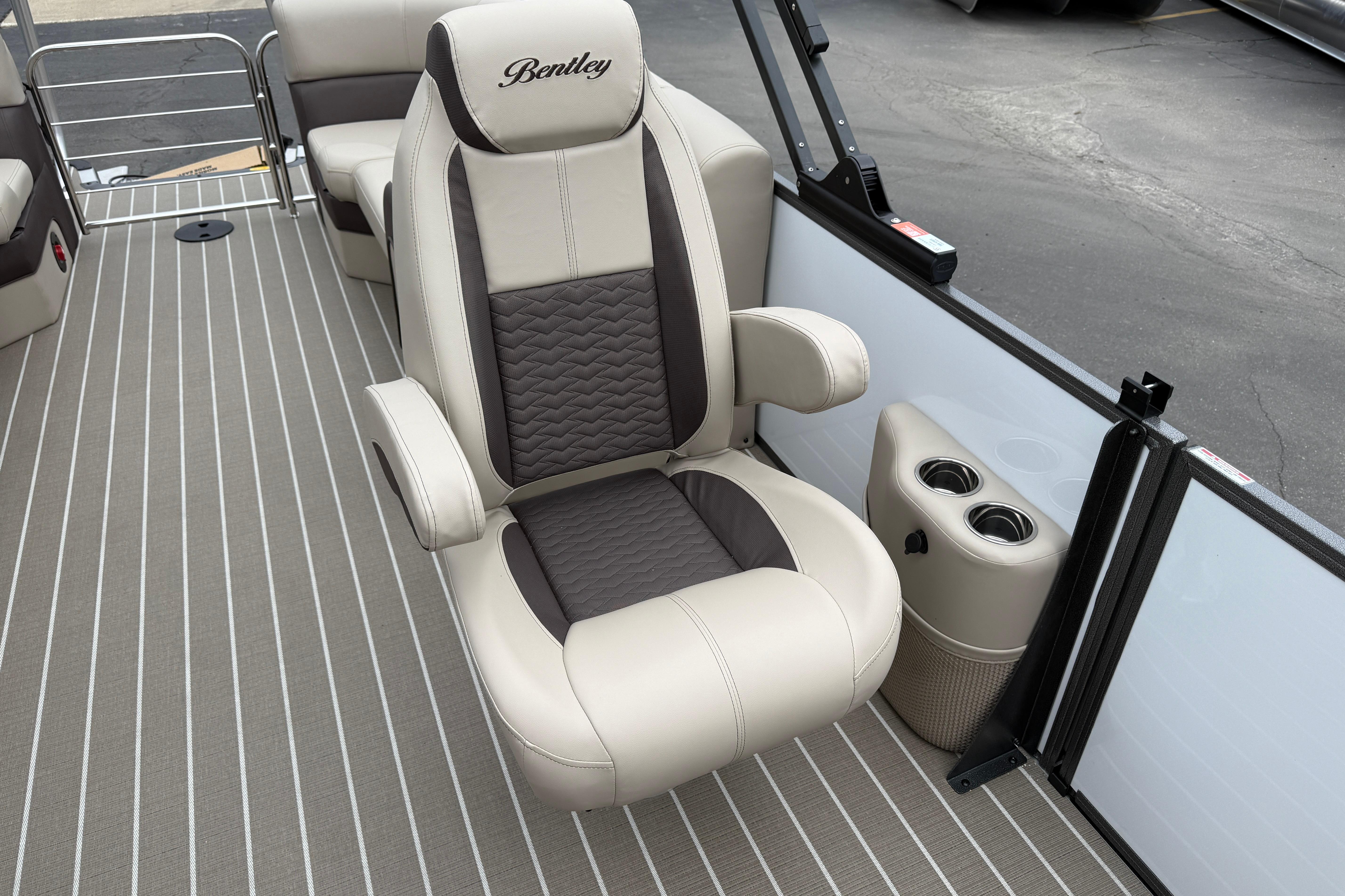 2026 Bentley Pontoons Elite 253 Admiral interior with luxurious captain's chair and cup holders.
