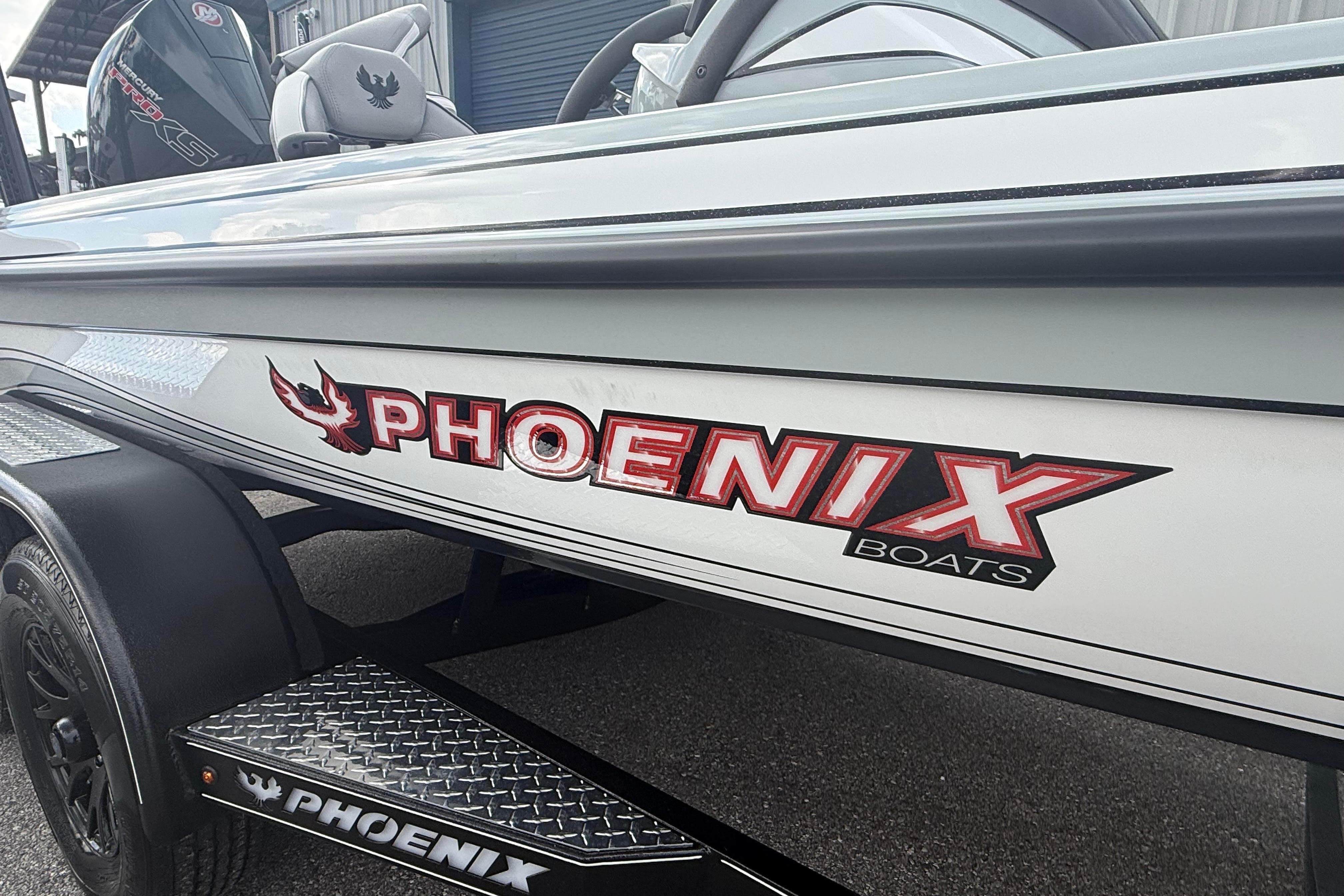 2027 Phoenix 921 Elite X II boat with logo, parked on a trailer.
