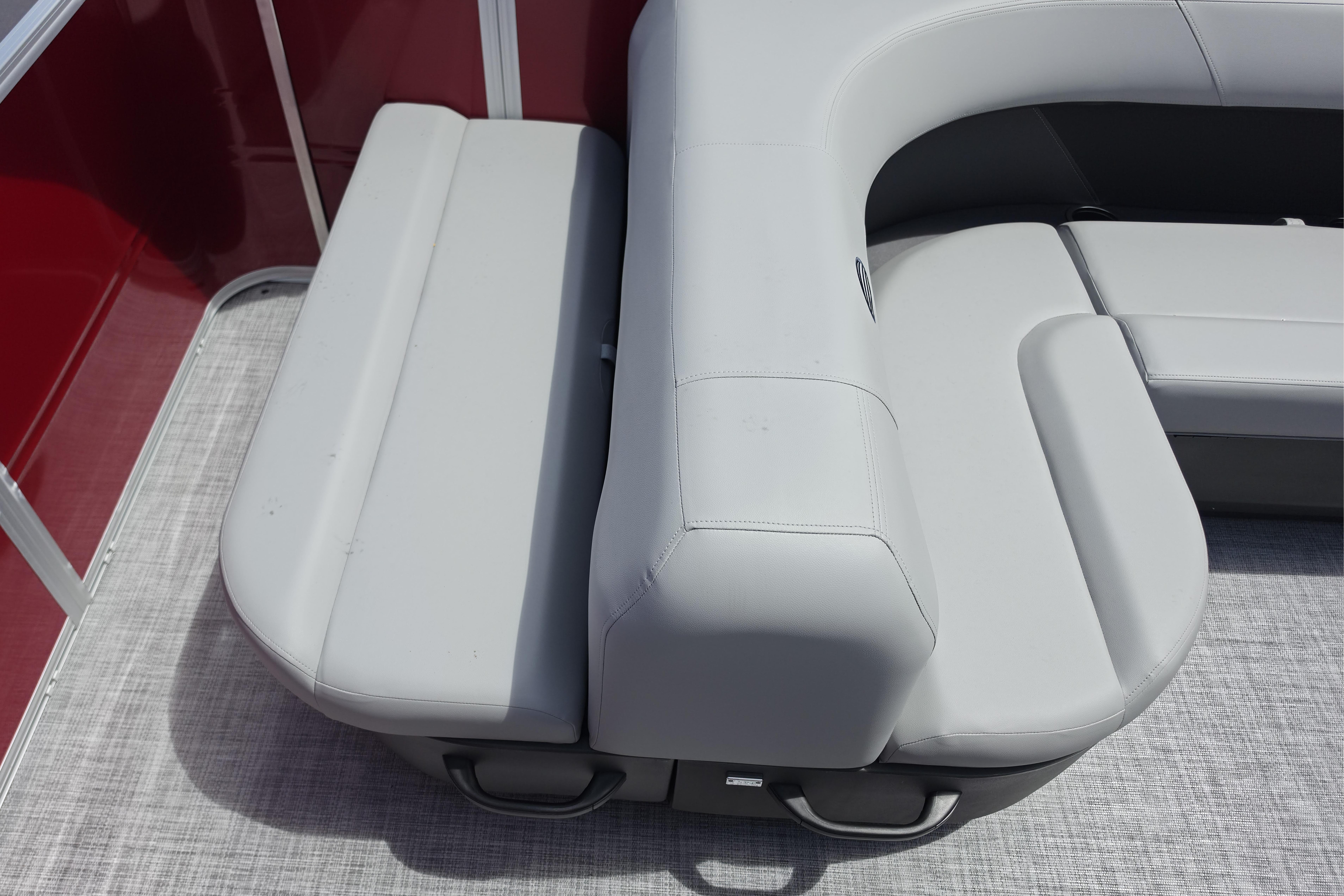 2026 Sun Tracker Party Barge 18 DLX with gray cushioned seating and red paneling.
