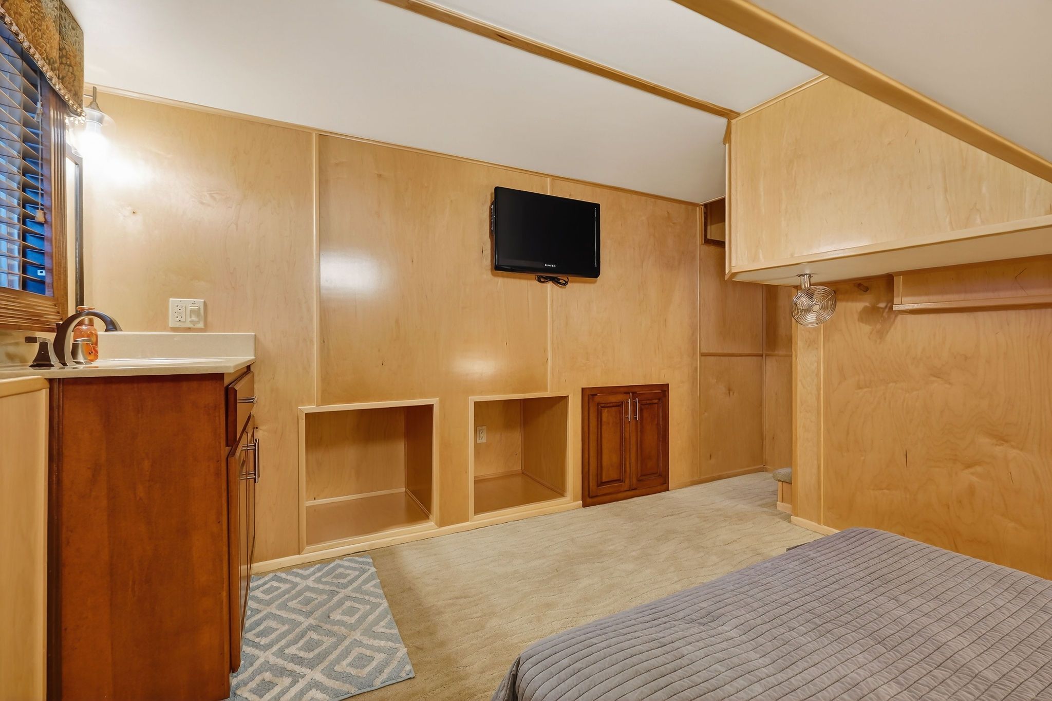 Interior of a 2010 Houseboat Throughbred with wood paneling and TV.