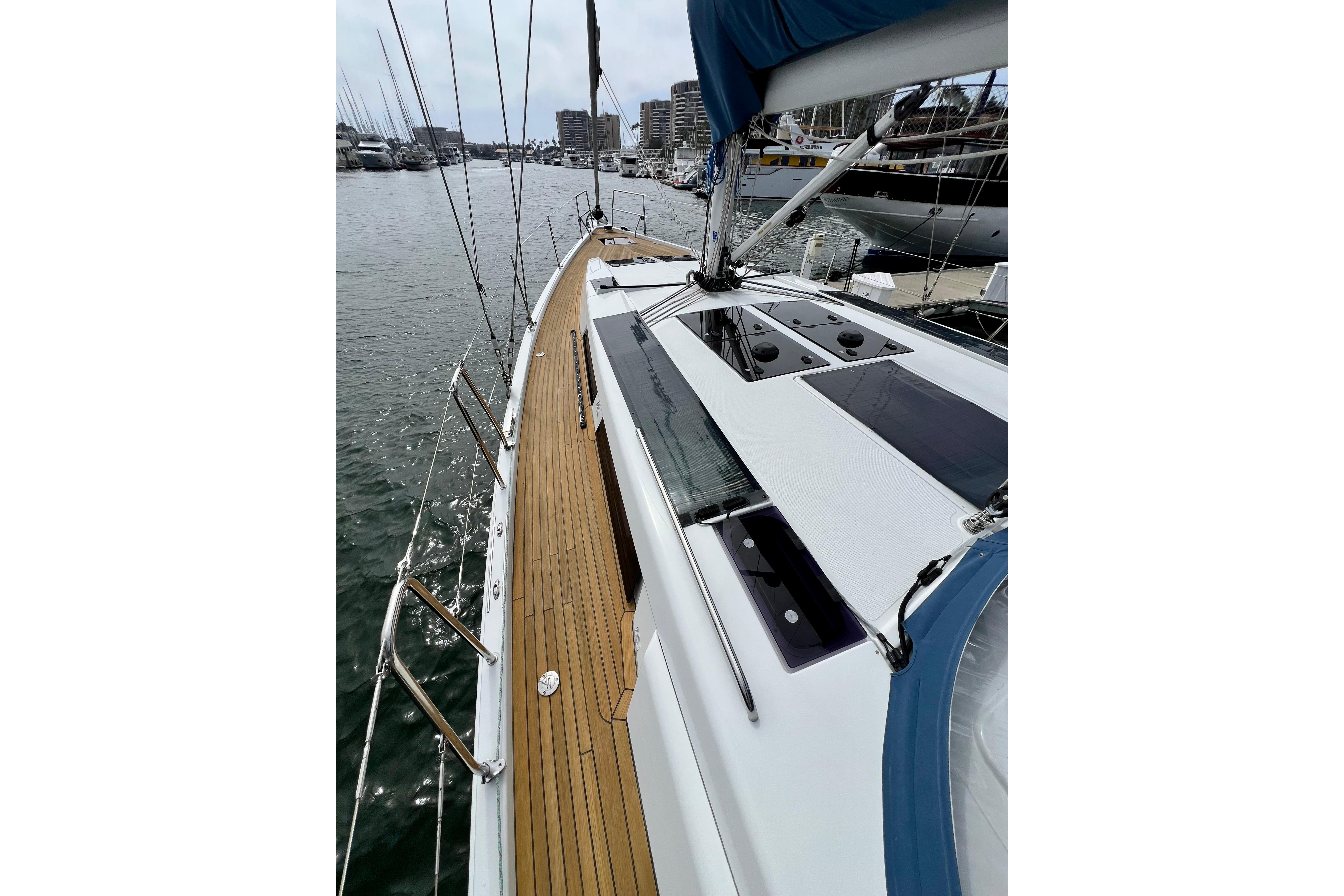 2016 Hanse 455 sailboat deck with teak finish, docked in a marina.