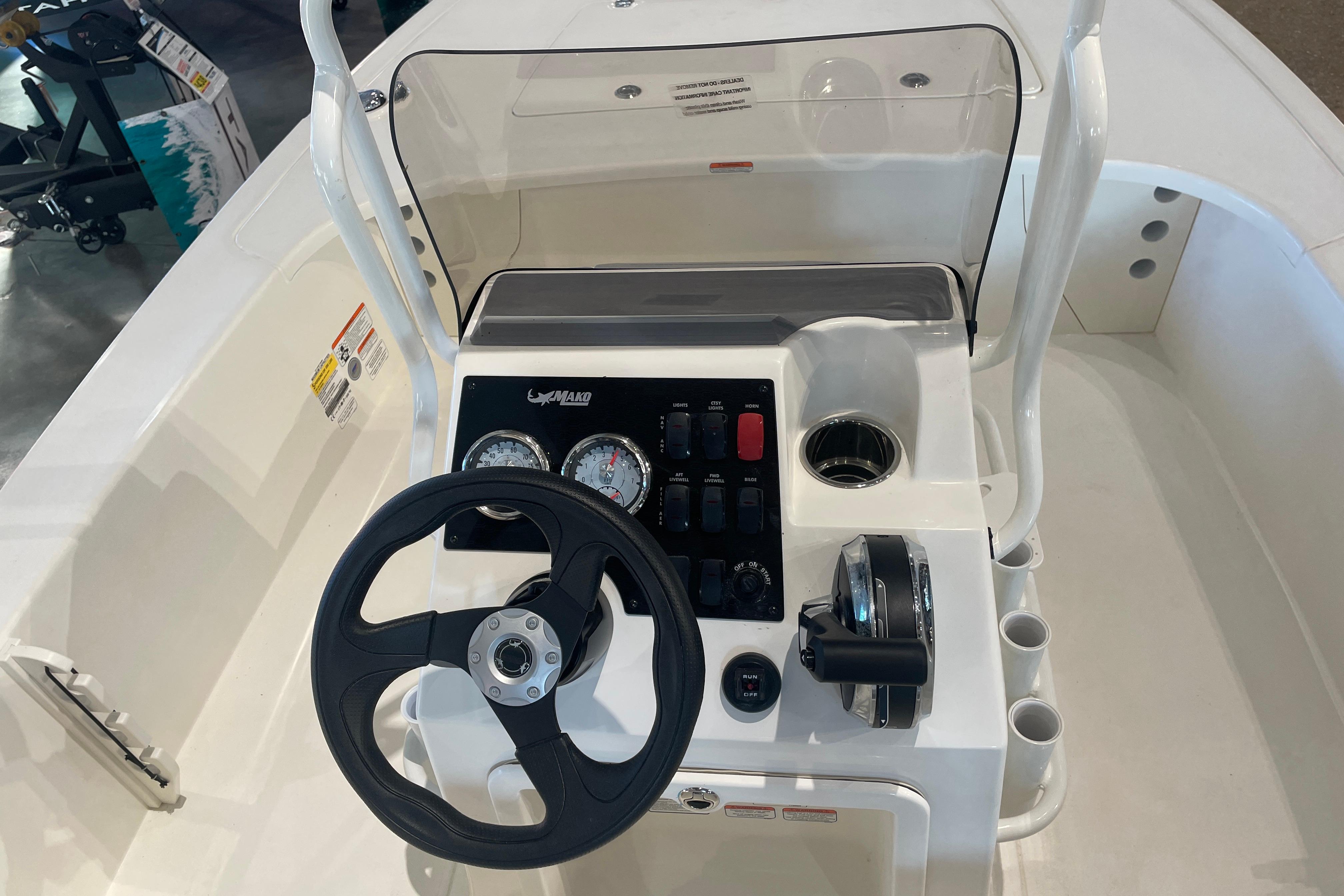 Steering console of 2026 Mako 18 Pro Skiff boat with gauges and controls.