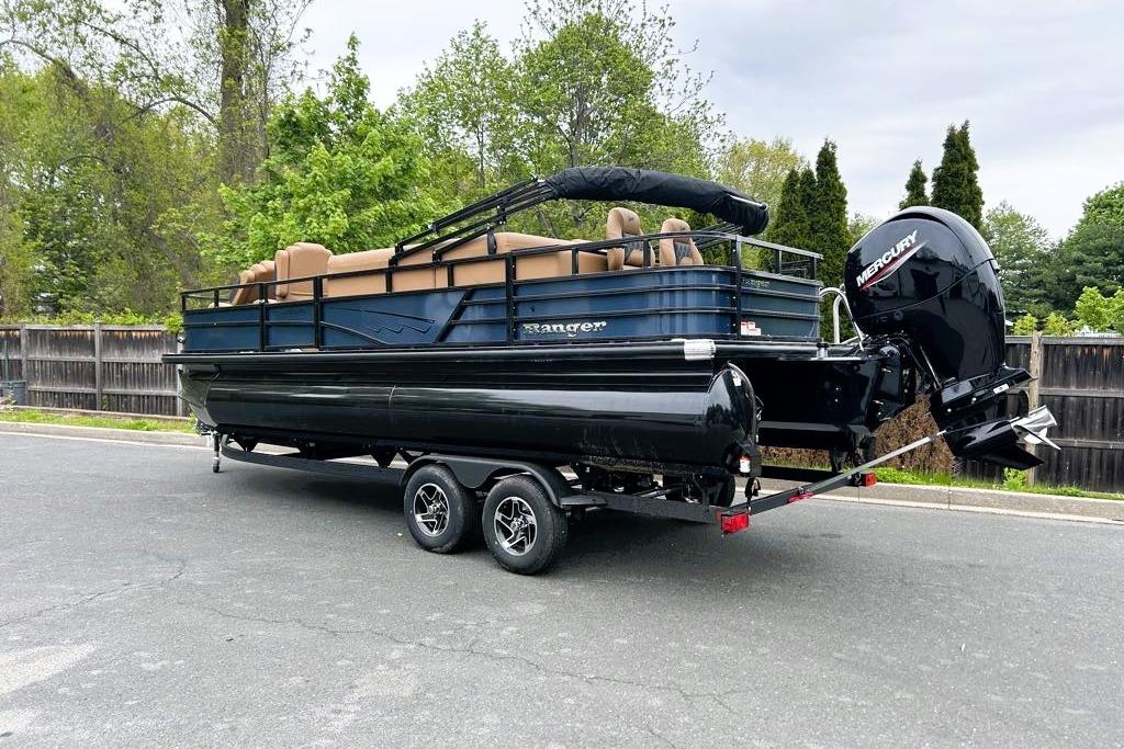 2026 Ranger 220FC pontoon boat on trailer, parked on road with trees in background.
