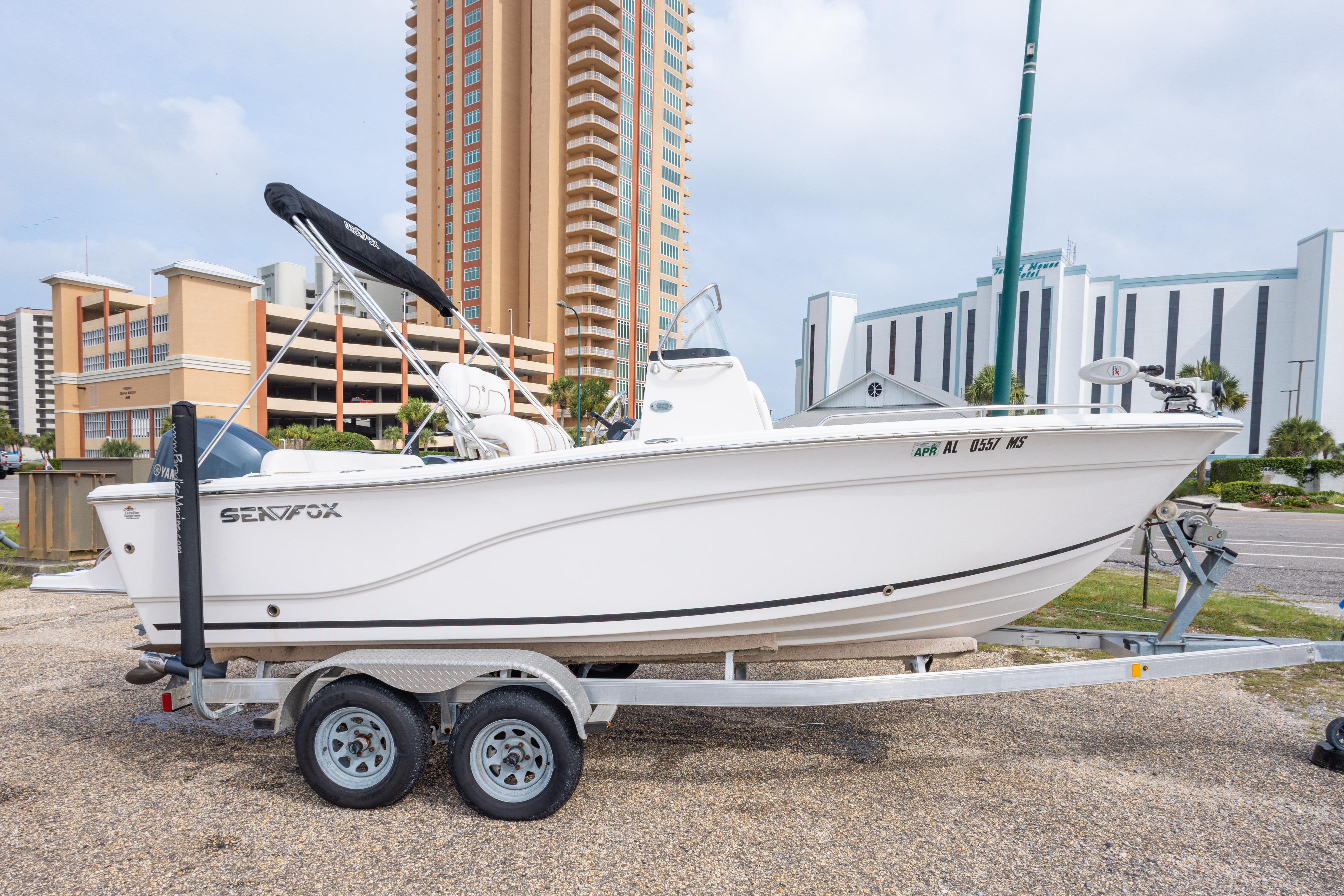 2014 Sea Fox 209 Commander boat on trailer, urban background with tall buildings.
