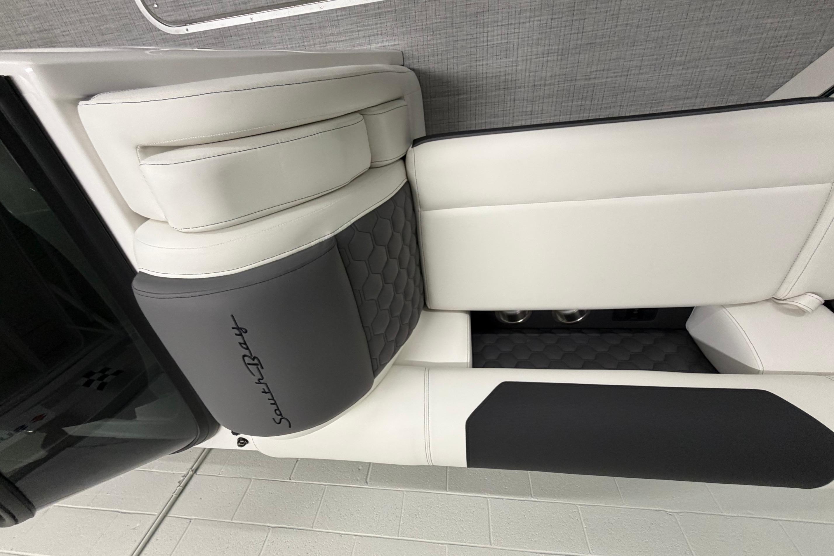 Luxurious interior of 2026 South Bay 525SB2 boat with sleek white and gray seating.