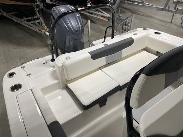 2025 Robalo R202 Explorer boat interior with seating and motor, in showroom setting.