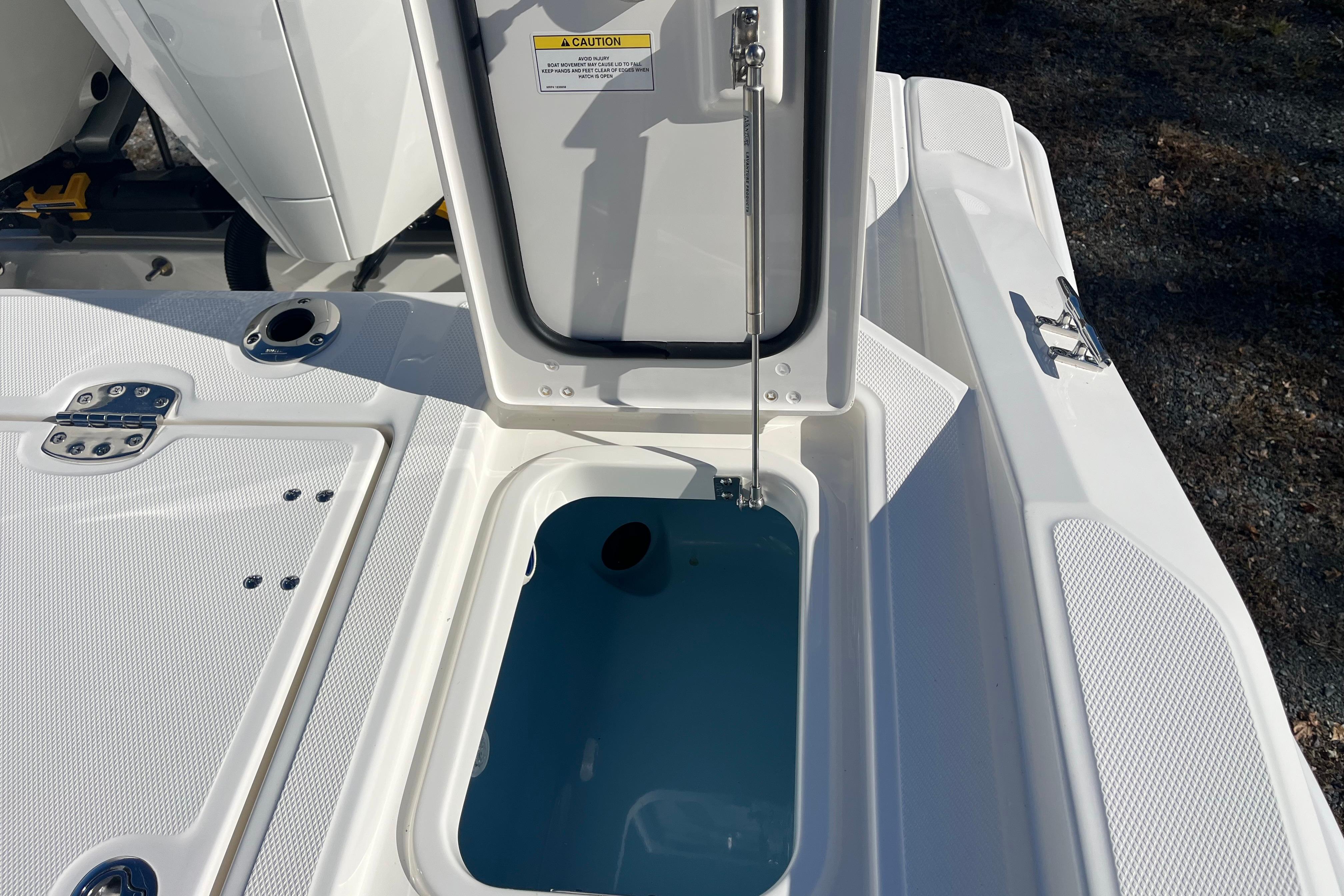 2026 Boston Whaler 280 Dauntless boat storage compartment open, showcasing interior details.