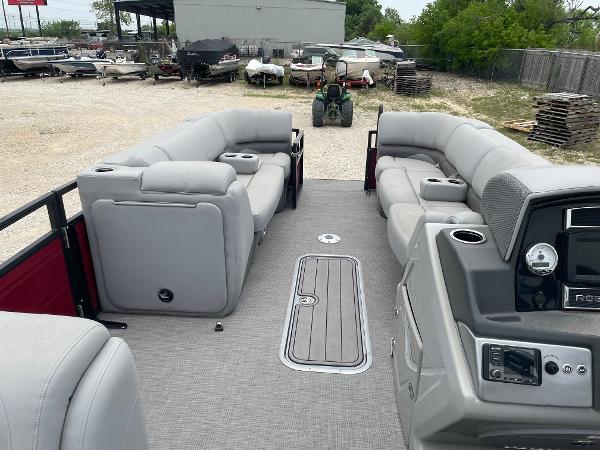 2023 Regency 250DL3 pontoon boat interior with gray seating and control panel.