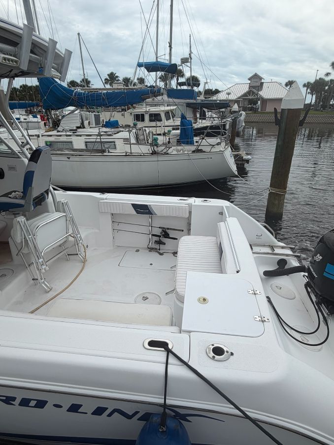 A 2003 Pro-Drive Walkaround boat docked in a harbor. Other boats are visible in the background.