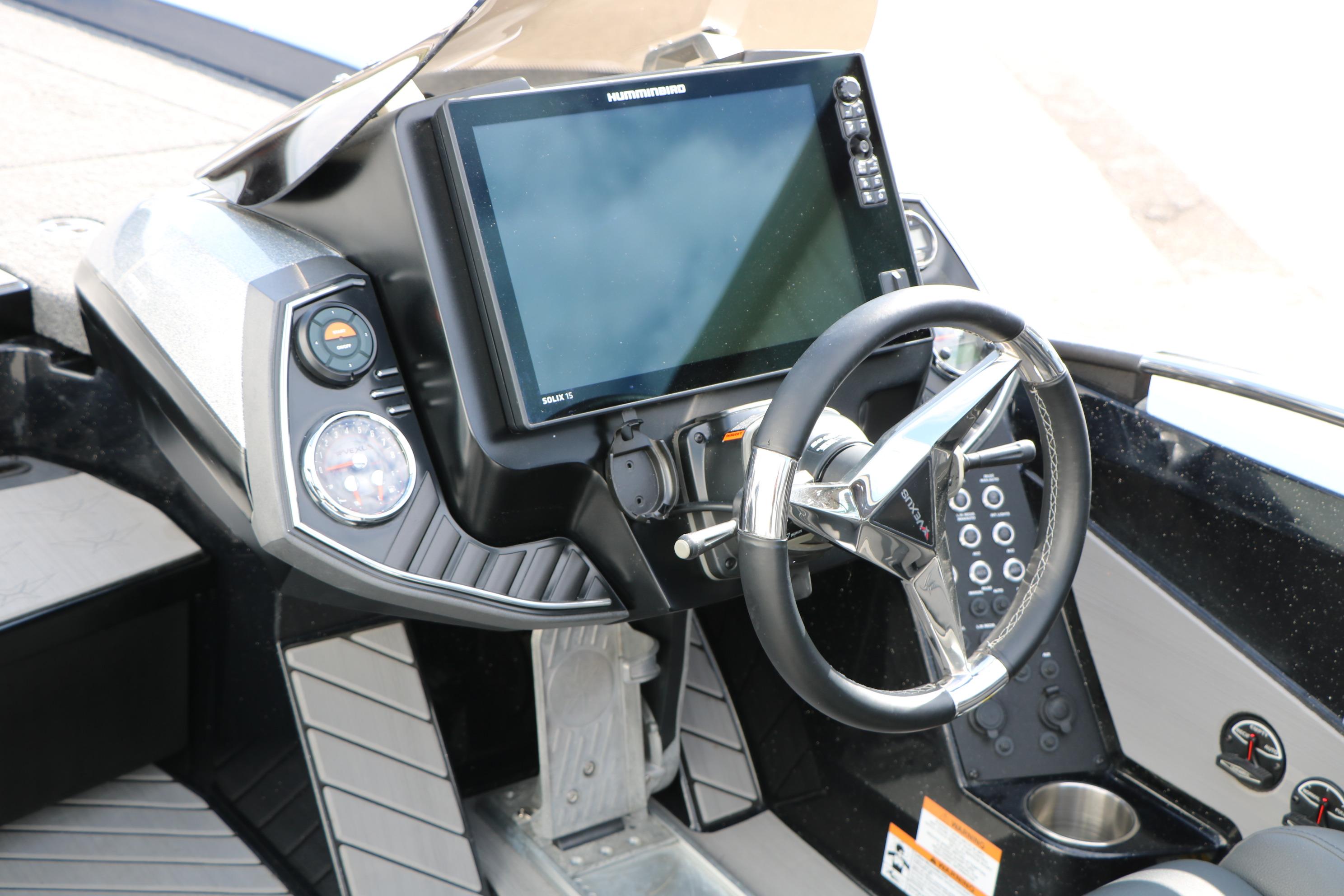 2022 Vexus VX21 boat dashboard with steering wheel and electronic display.