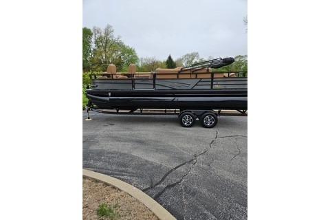 2026 Ranger 220FC boat on trailer, parked outdoors with trees in the background.