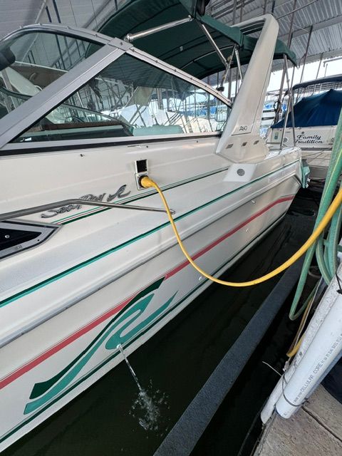 A 1992 Sea Ray 290 Sundancer is docked, with a yellow cable connected.
