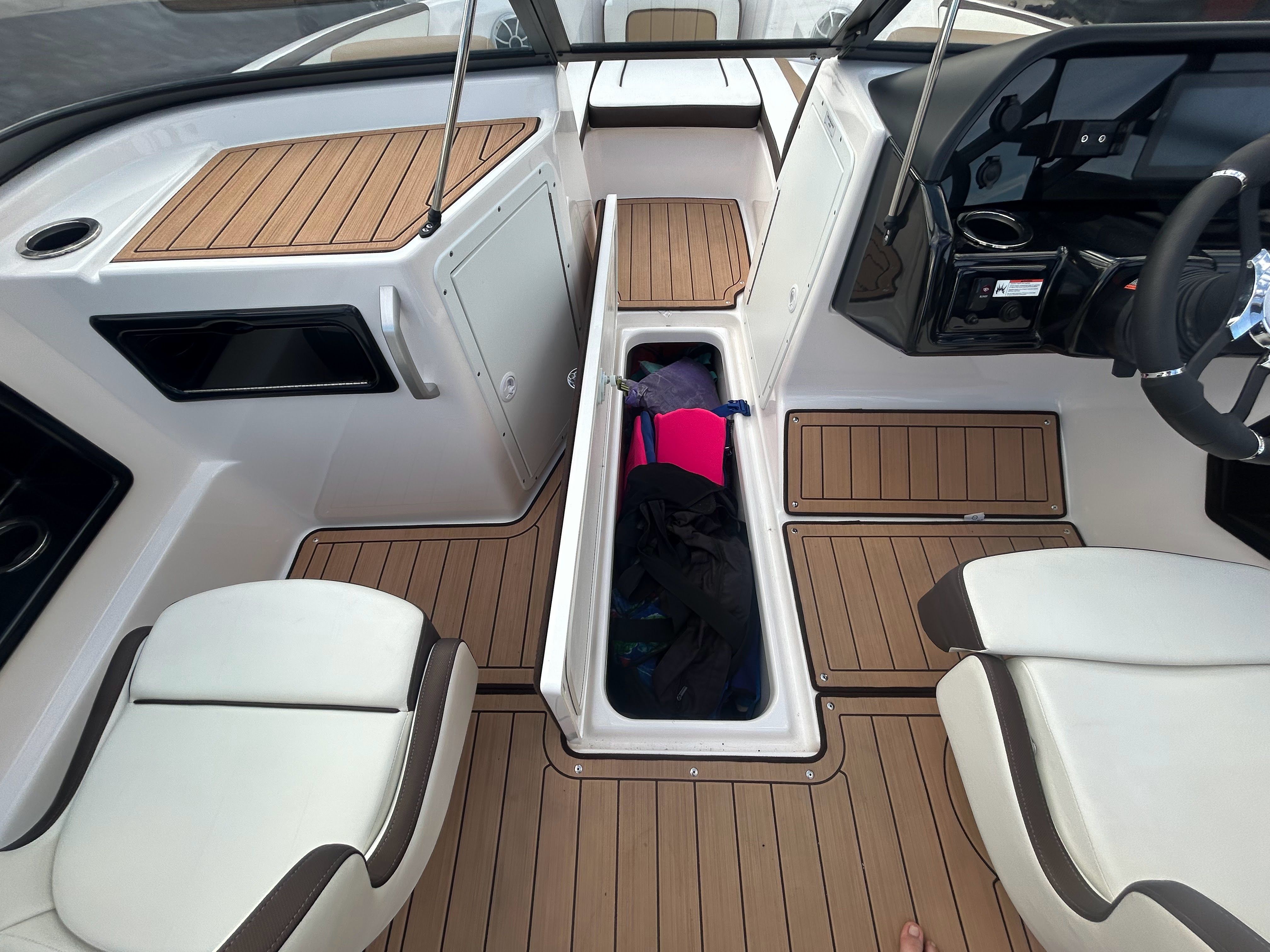 Interior of a 2022 Yamaha Boats 195S with storage and seating.