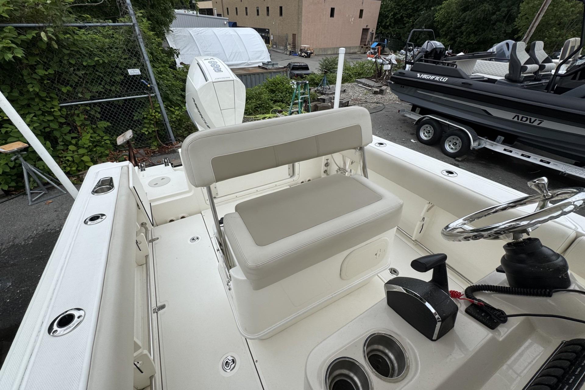 2024 Boston Whaler 230 Outrage boat interior with helm, seating, and controls.