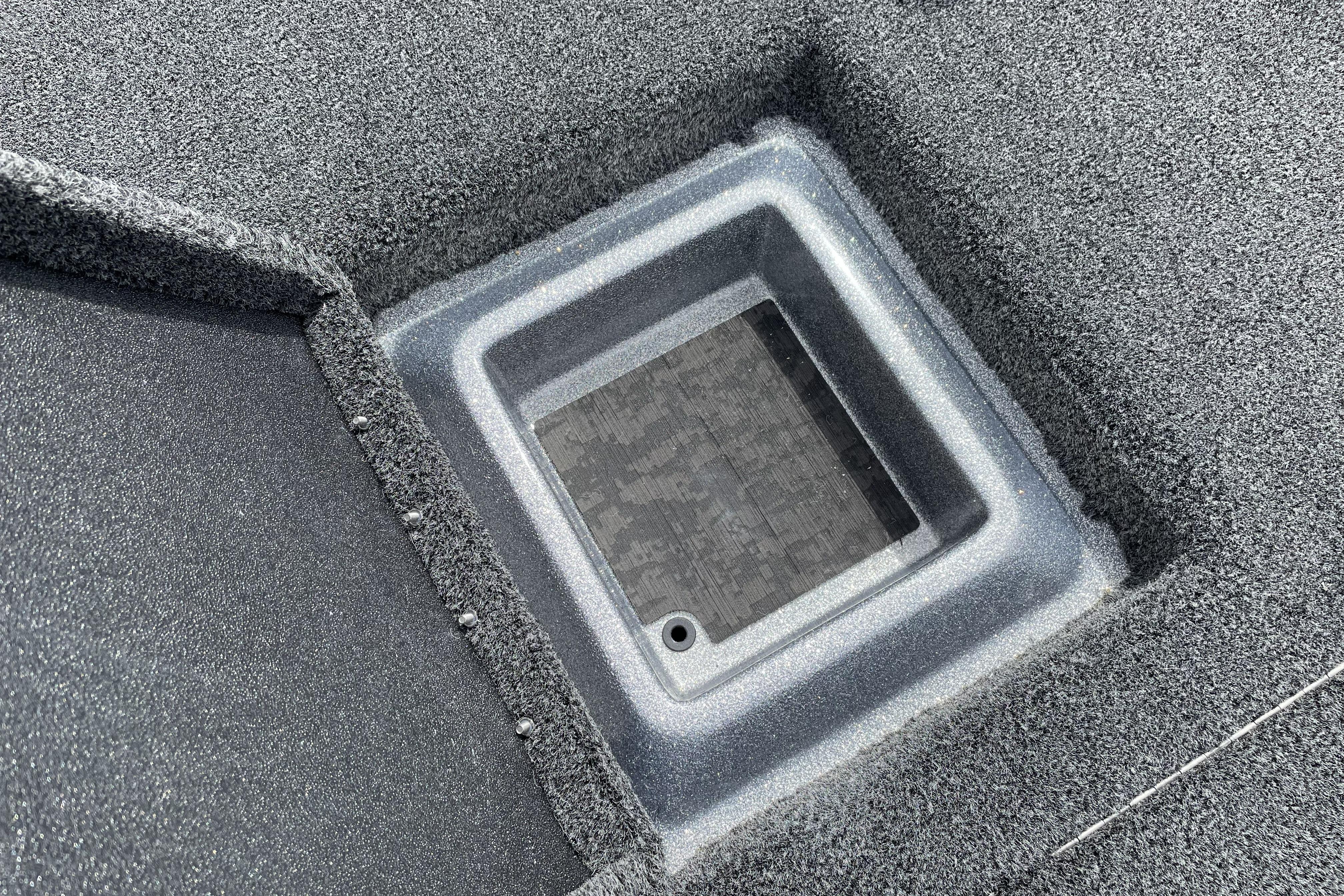 Carpeted storage compartment on 2026 Nitro Z21 XL boat deck.