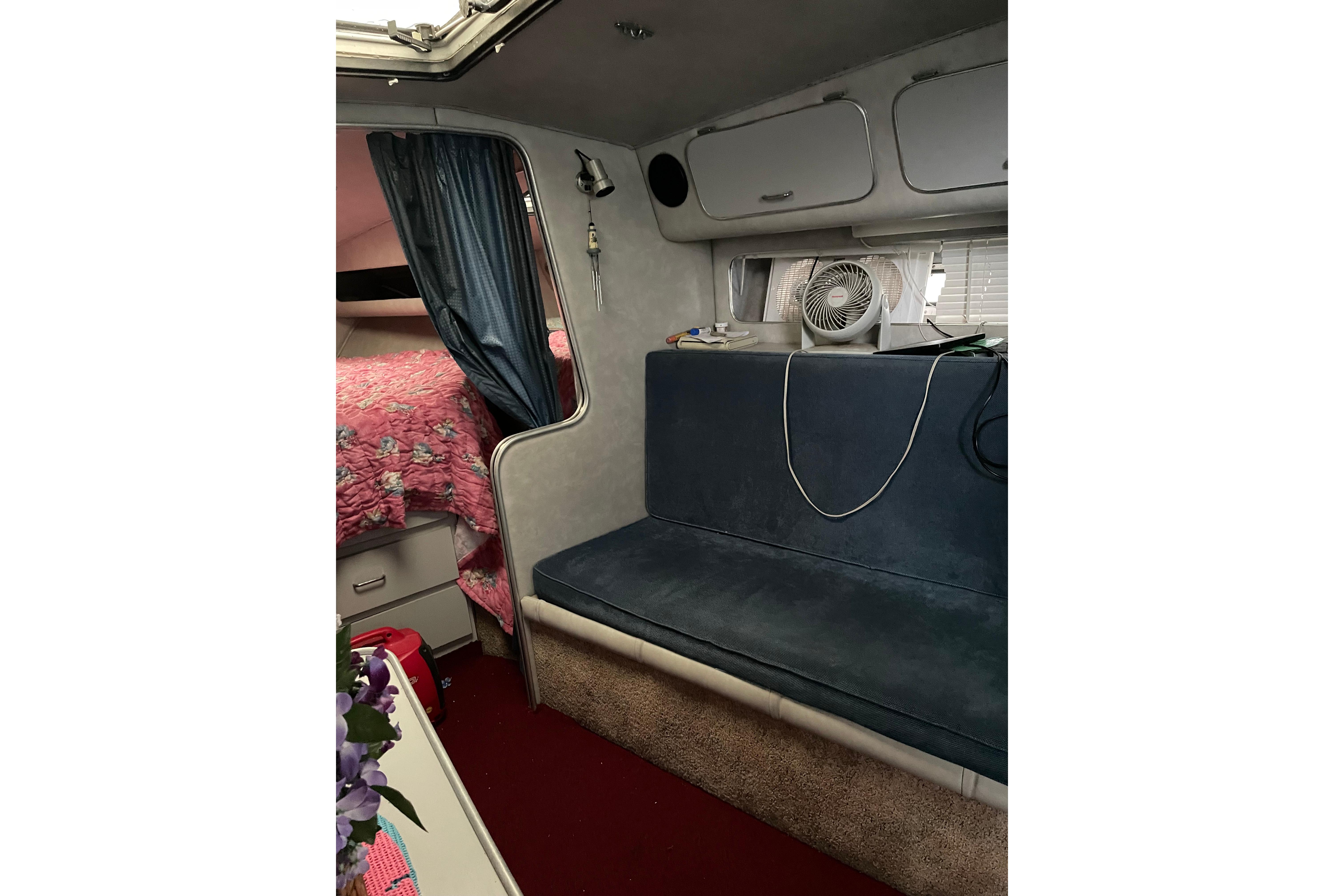 Interior of 1987 Chris-Craft 332 Amerosport with seating, storage, and cozy decor.