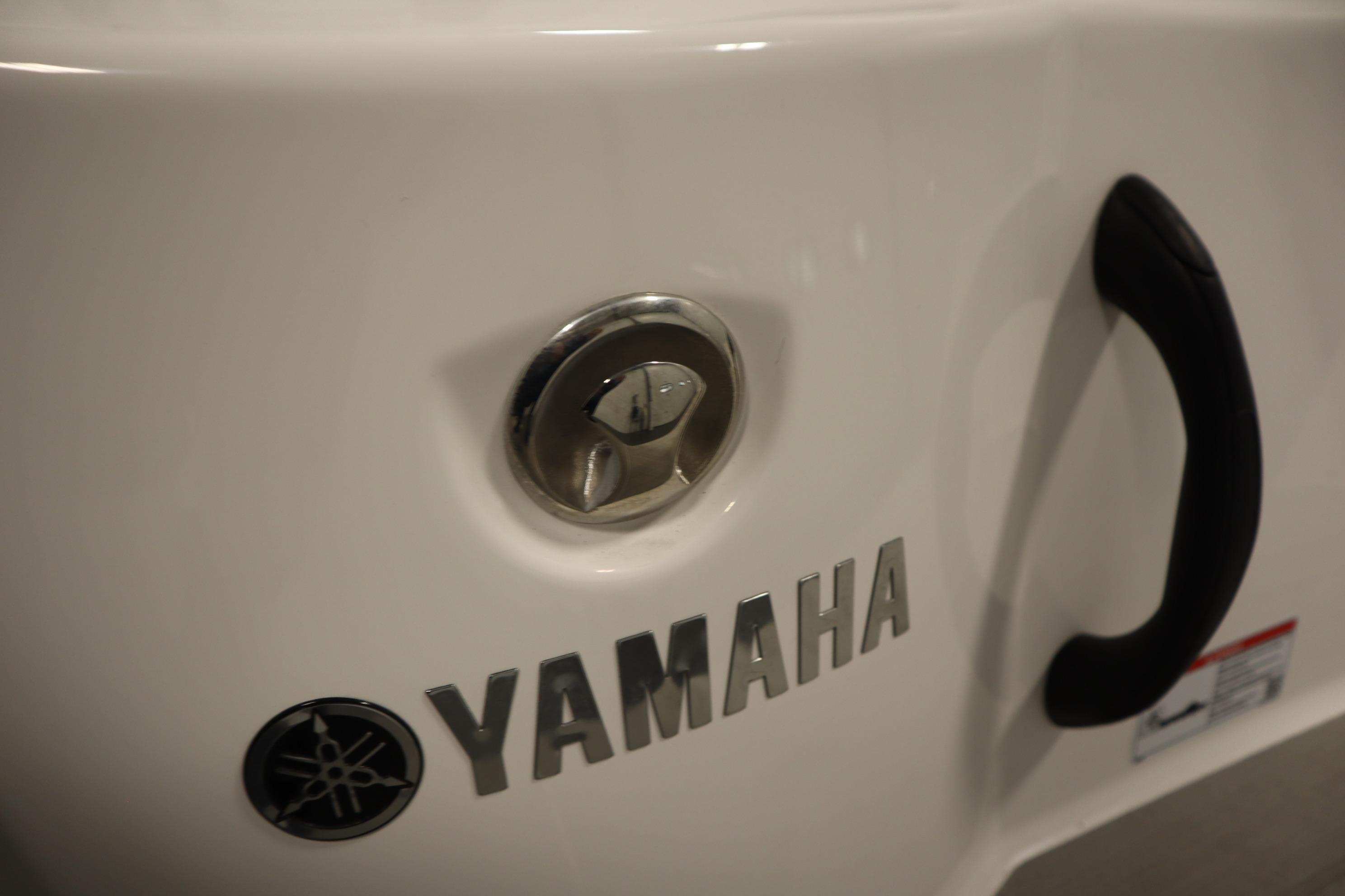 2026 Yamaha Boats AR220 logo and handle detail on white surface.