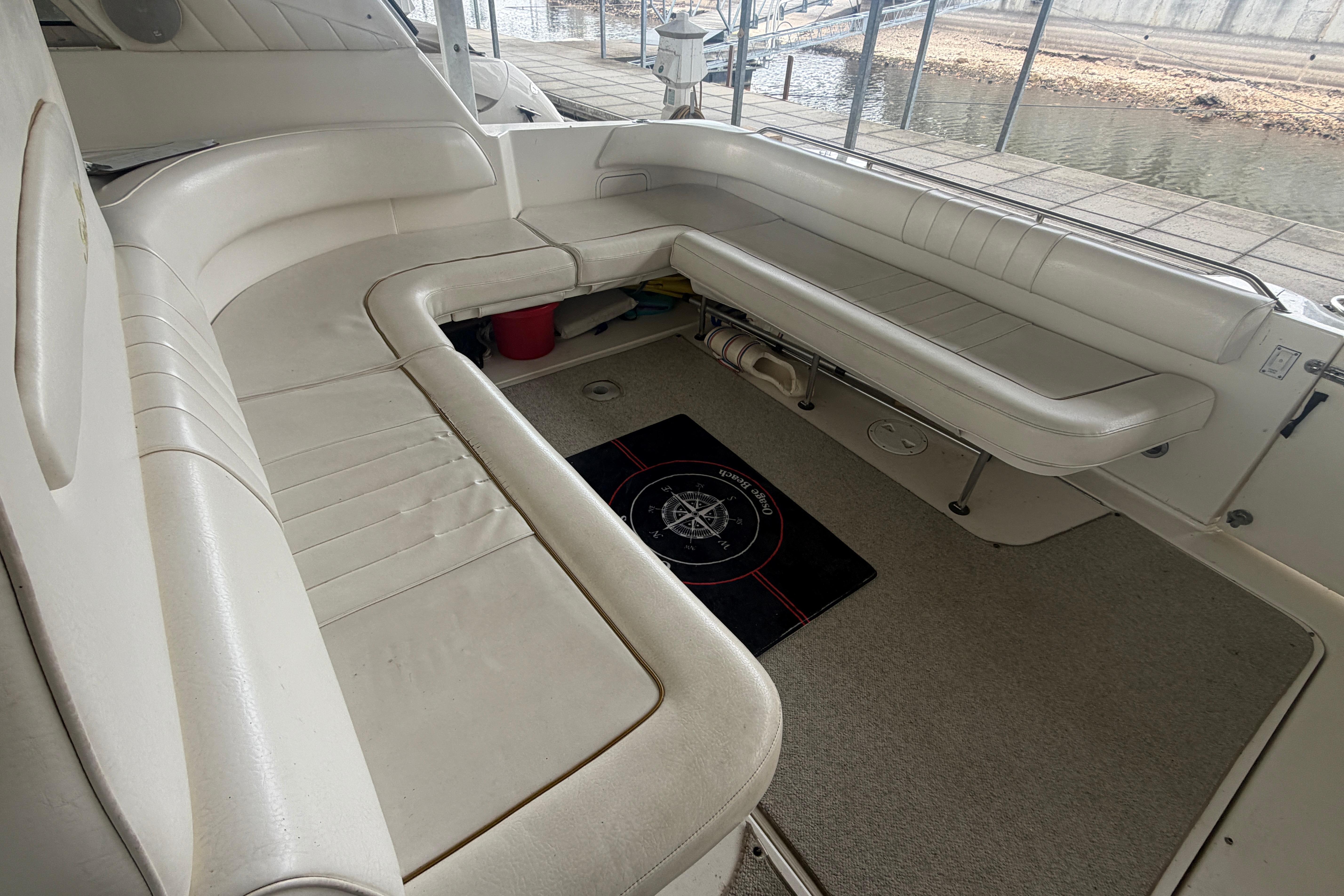 1999 Sea Ray 400 Sundancer boat interior with white seating and carpeted floor.