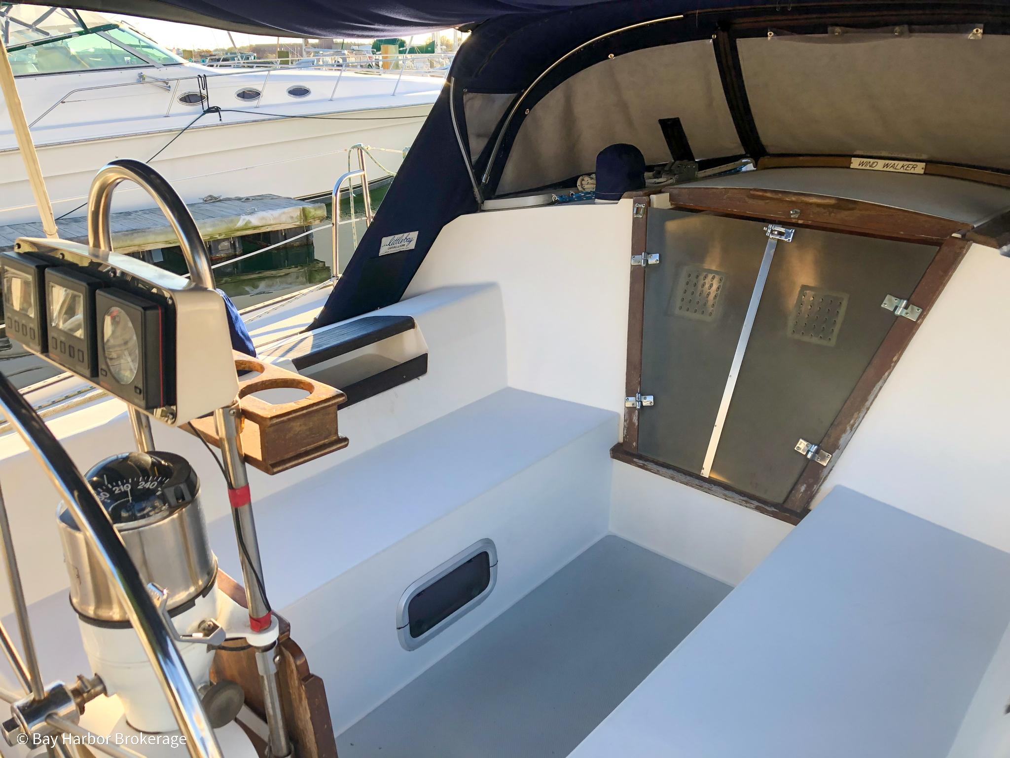 Cockpit of a 1992 Catalina 42 sailboat with steering wheel and seating.